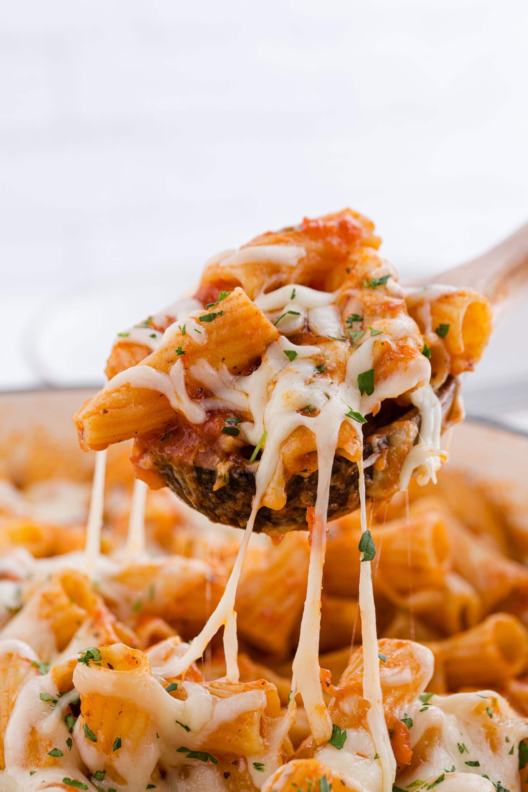 a spoonful of one pot chicken parmesan pasta recipe with gooey cheese