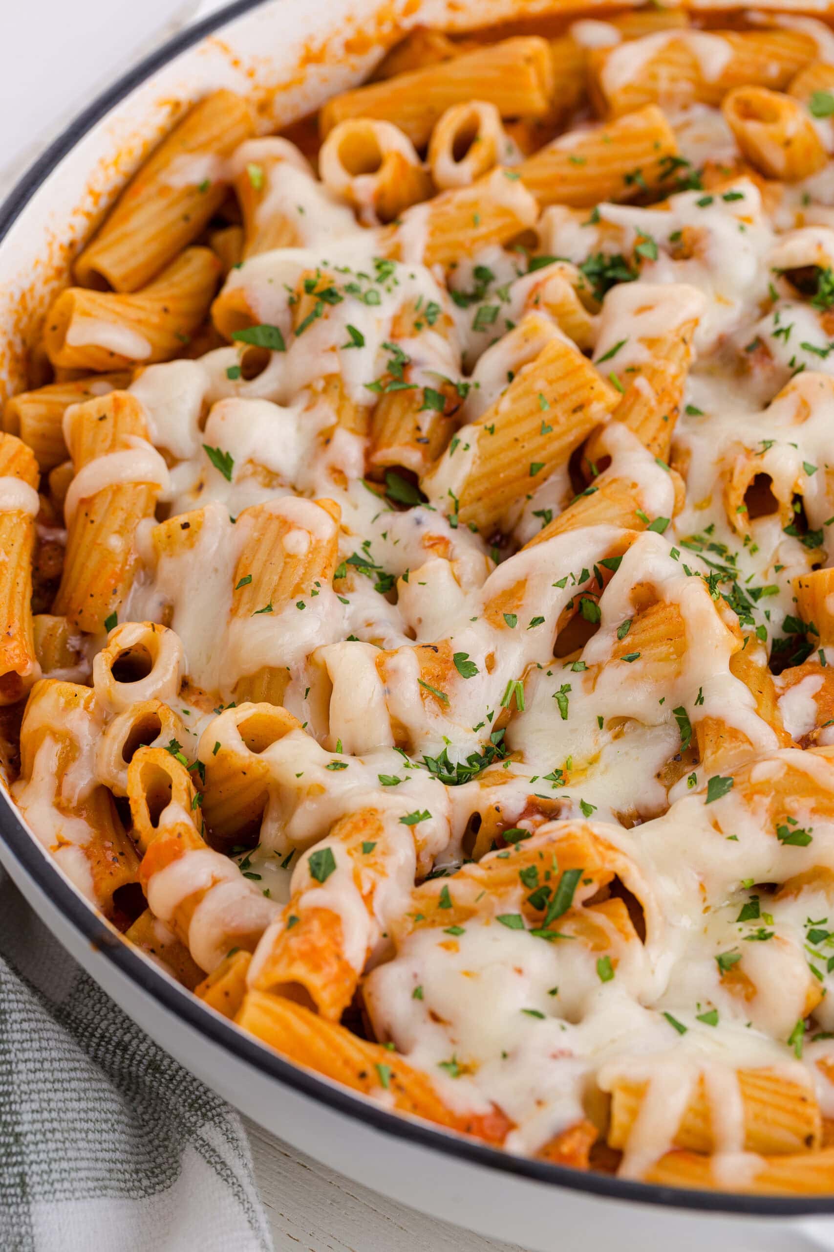 a pot of one pot chicken parmesan pasta recipe topped with melted cheese