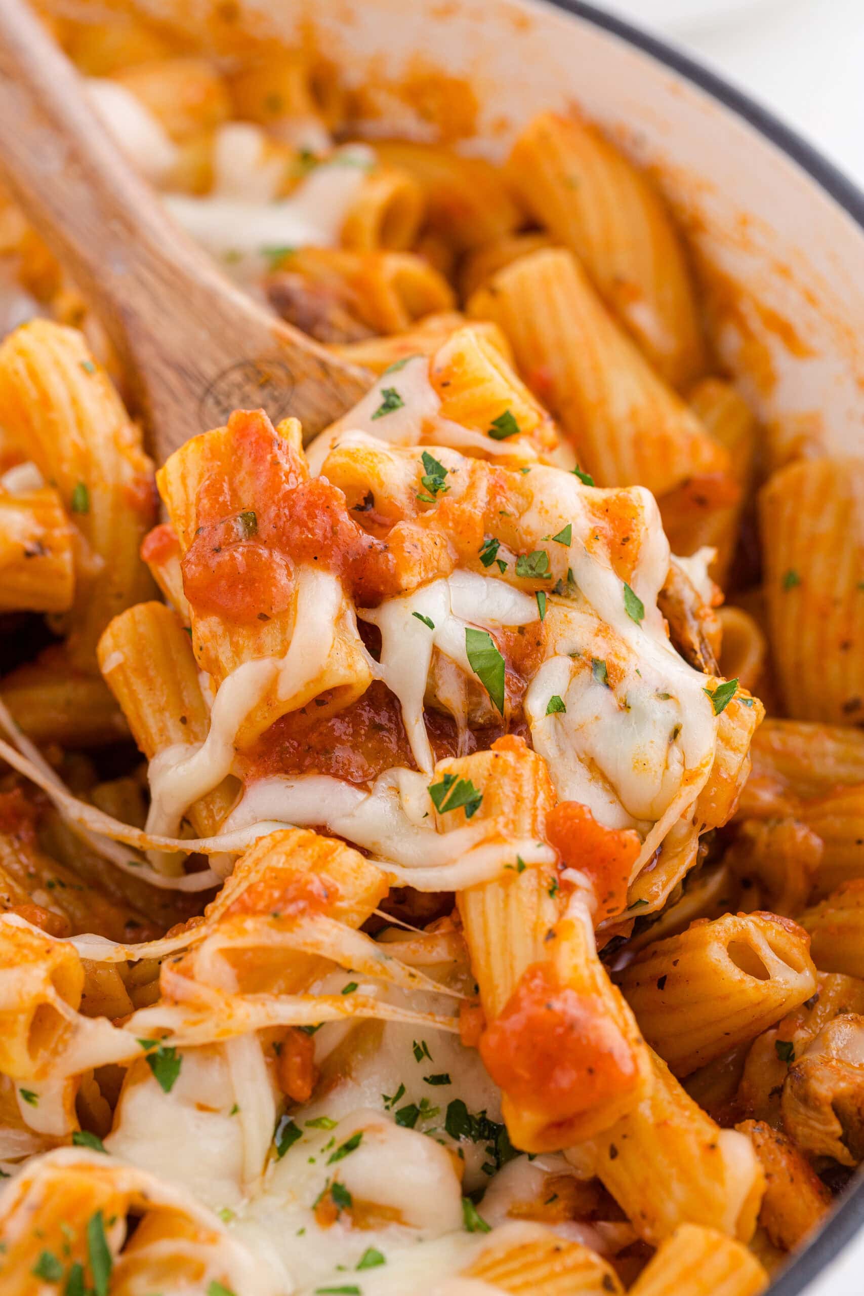 a spoonful of one pot chicken parmesan pasta recipe topped with melted cheese