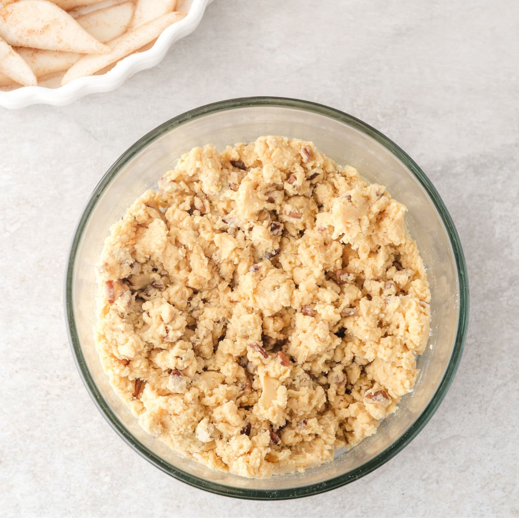 Cake mix is mixed in with melted butter, nuts, and sugar