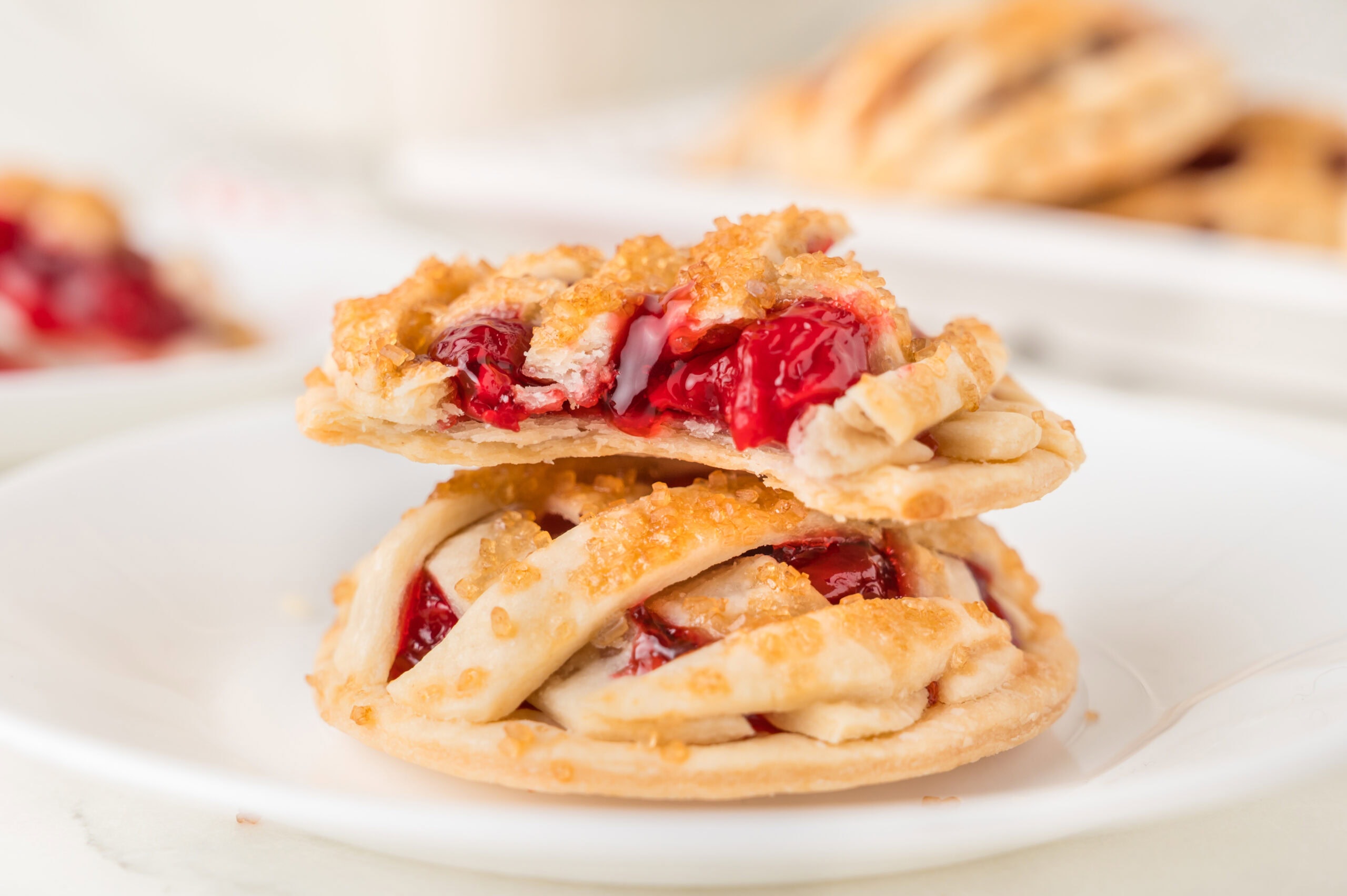 A bite taken out of a cherry pie cookie to show the gooey fruity filling