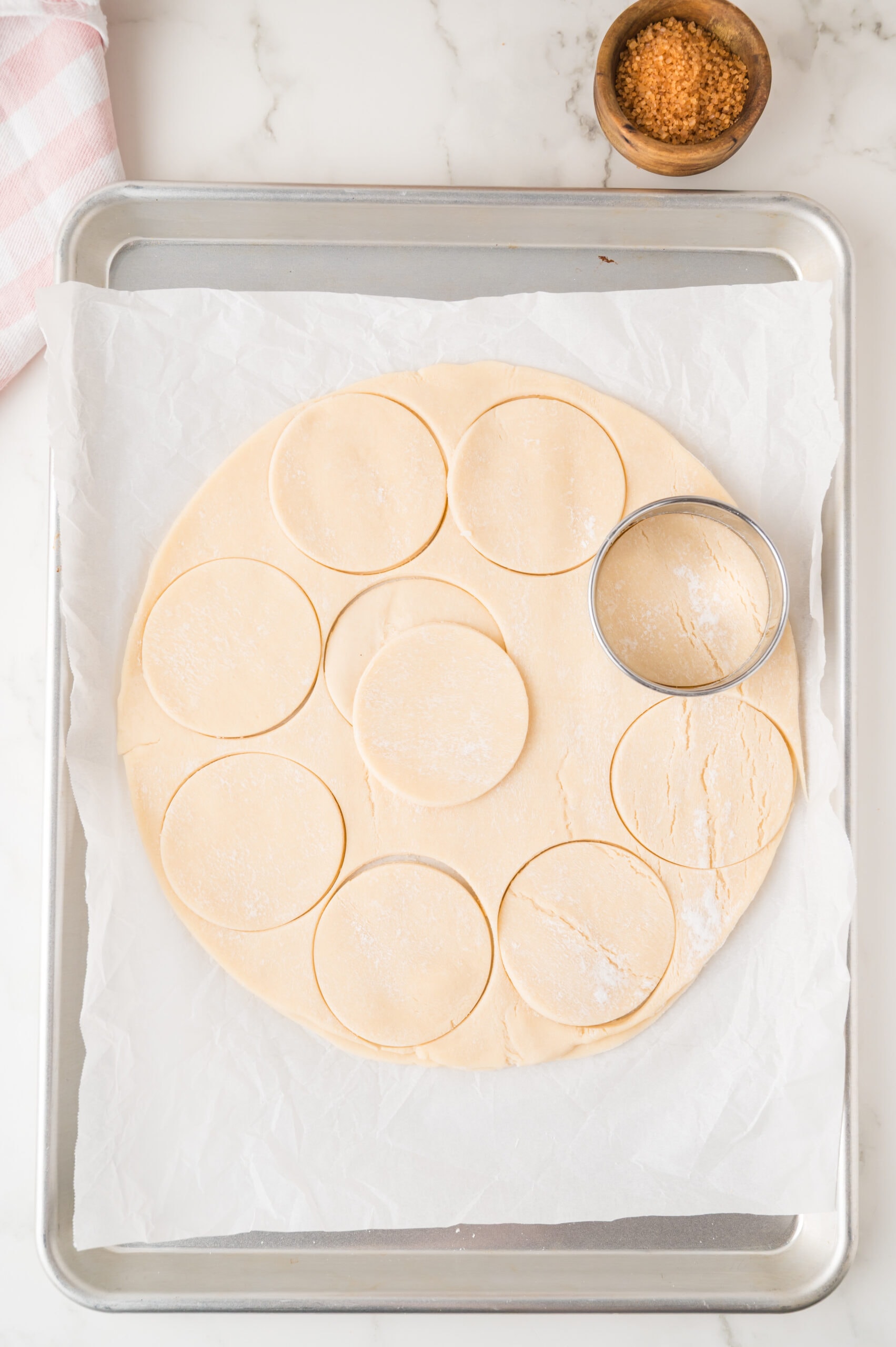 Cutting out circle in pie dough to create a cookie shape