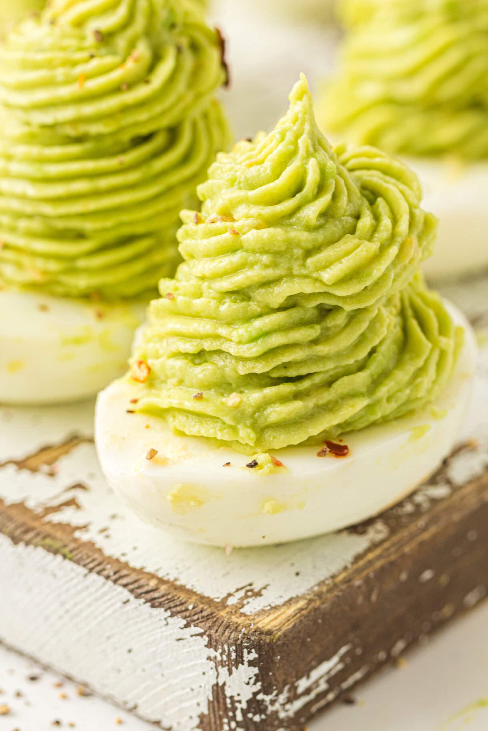 Christmas tree deviled eggs all piped into the  prepared egg whites and ready to be served