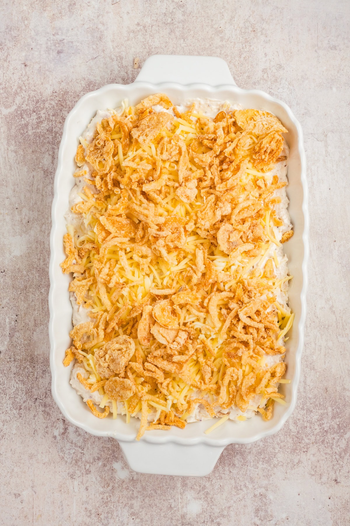 French fried onions are added to the top of the casserole