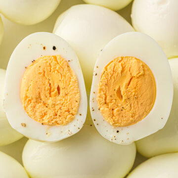 a close up of easy peel hard boiled eggs in the Instant Pot sprinkled with pepper