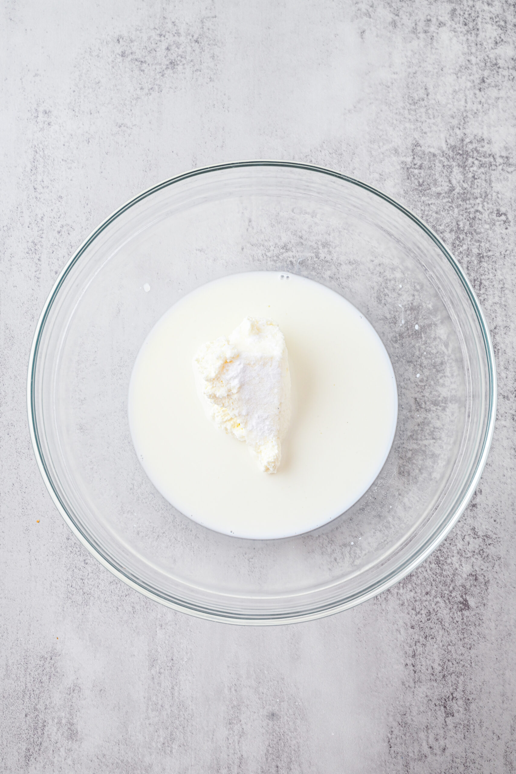 In a large bowl, combine milk, ricotta cheese, baking soda and salt.First process step