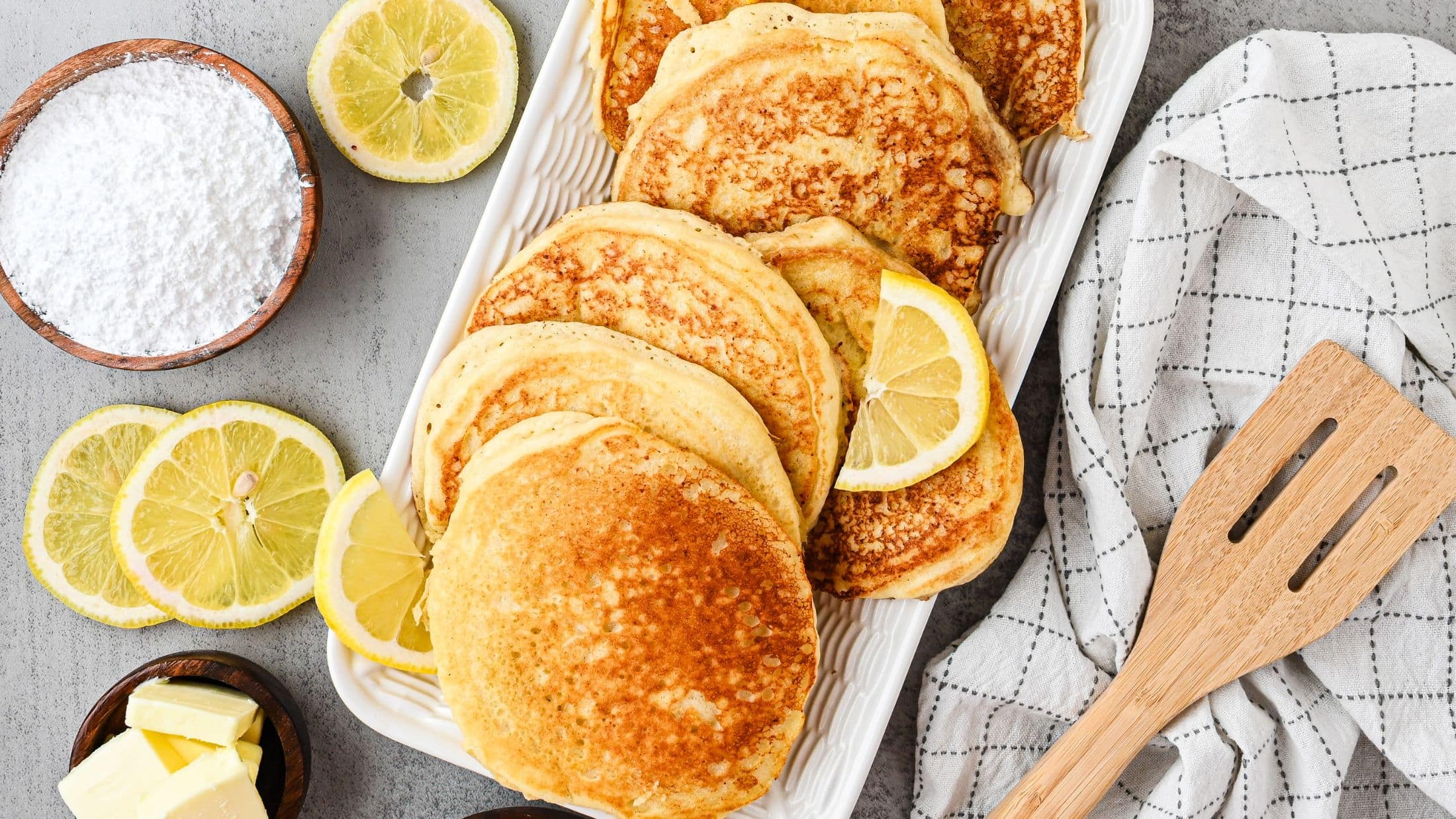 Lemon Ricotta pancakes fresh from the pan, still warm on a plate ready to add delicious toppings.