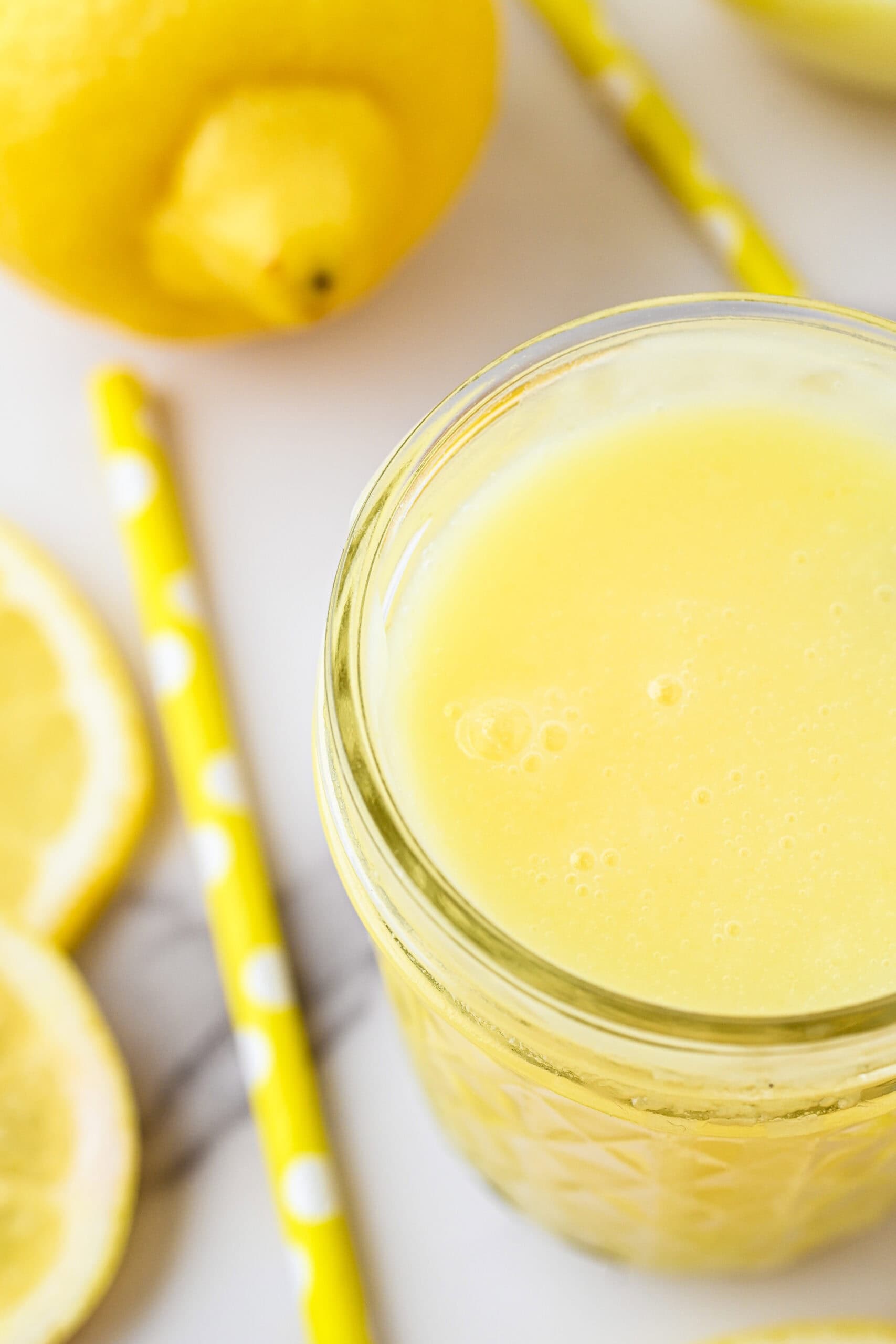 Lemon syrup simmered, cooled, and poured into a jar, ready to be served