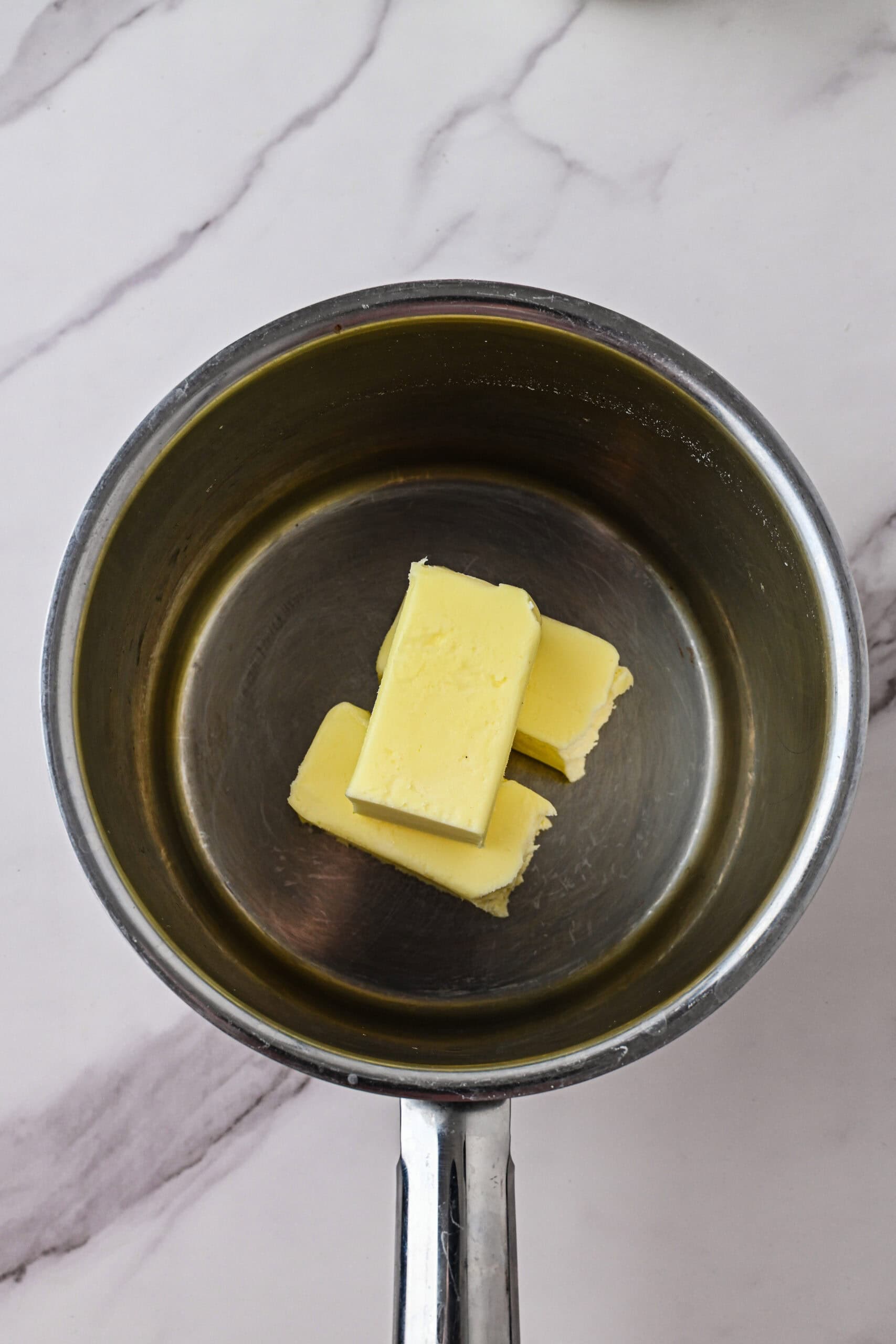 Soft butter added to the small saucepan ready to be slowly melted