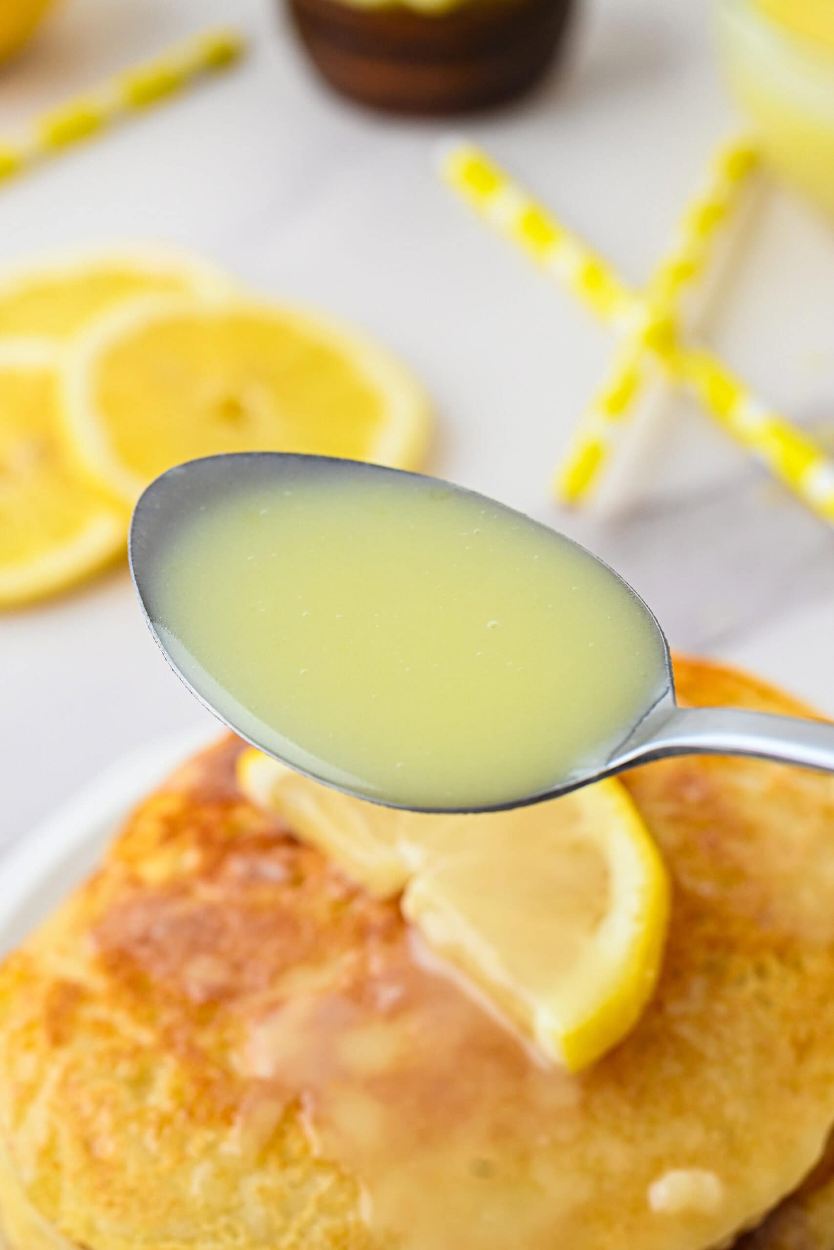 A close up of the lemon syrup on a spoon to show its texture