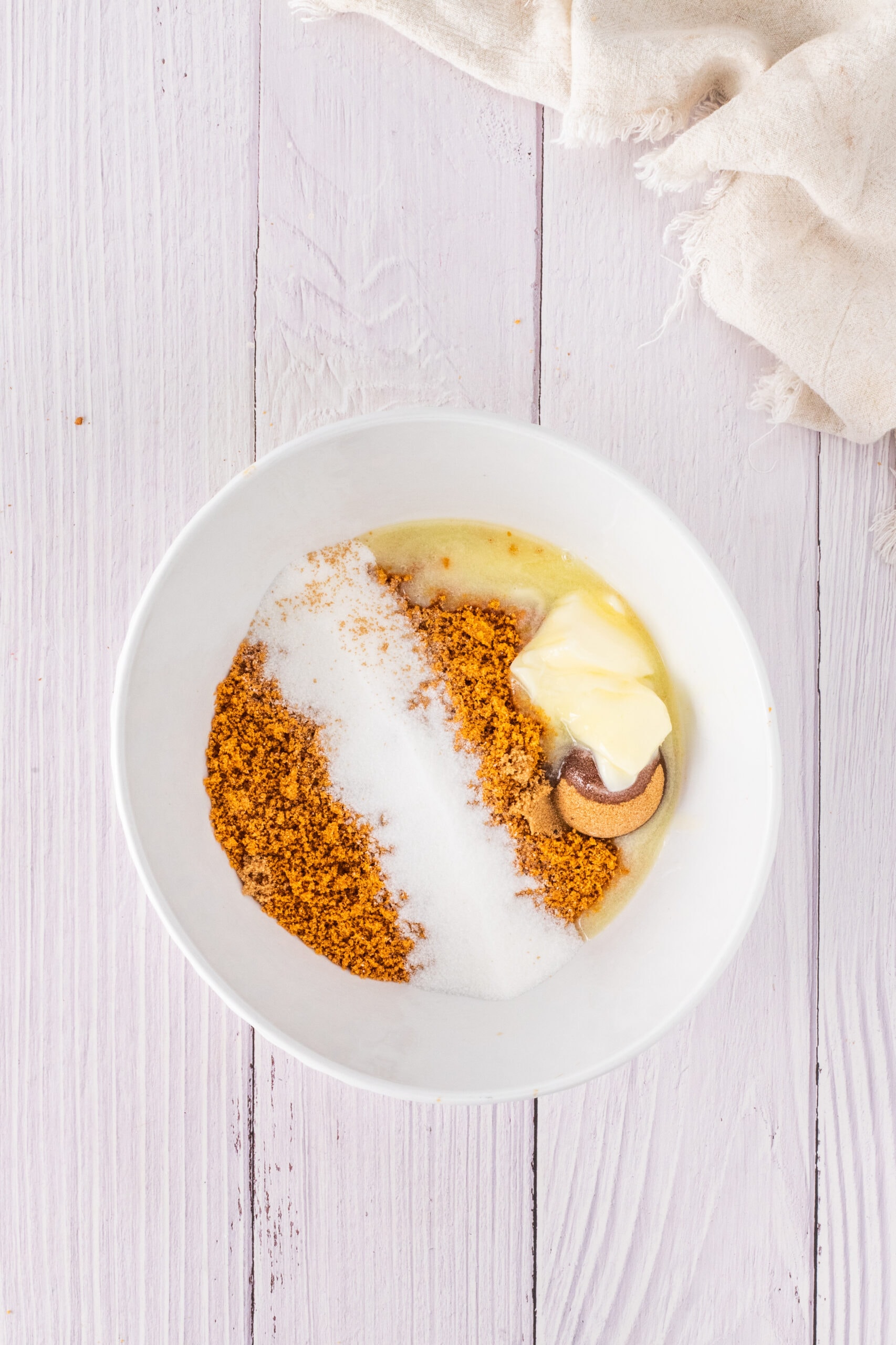 Creating the graham cracker crust with Biscoff cookies, brown sugar, melted butter and sugar