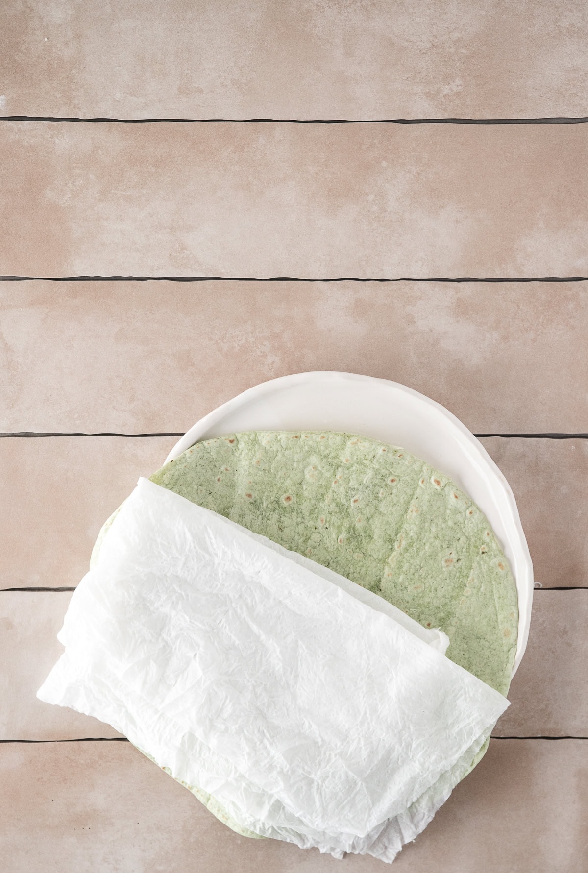 Tortilla ready to be wrapped in a damp paper towel