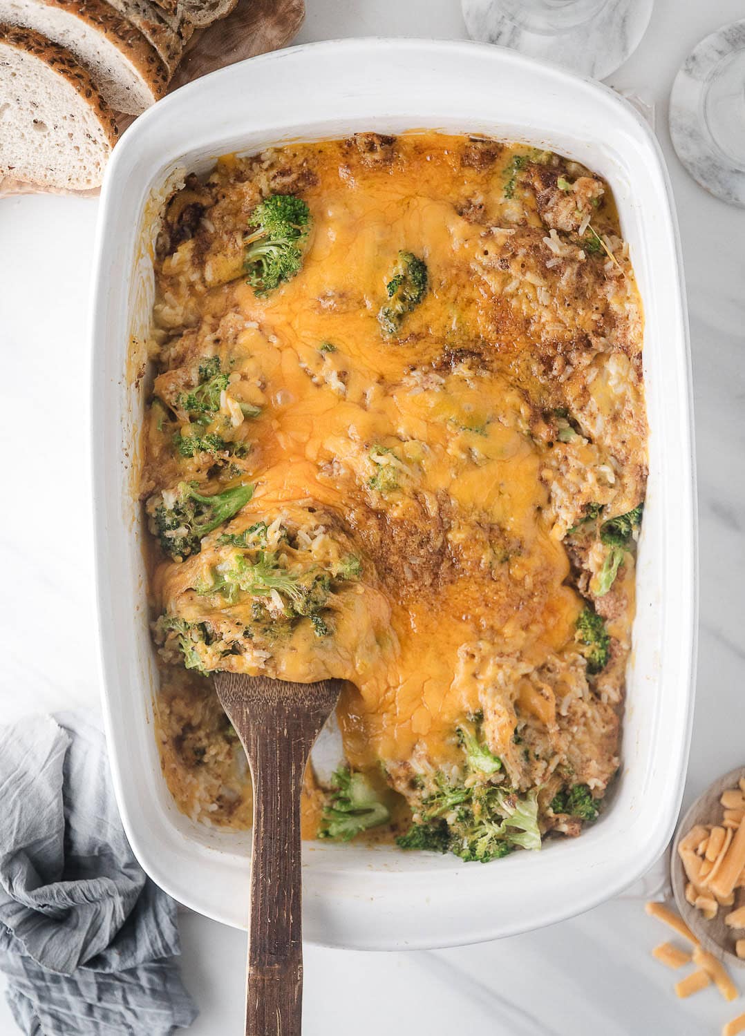 broccoli cheese and rice casserole just baked with a serving spoon