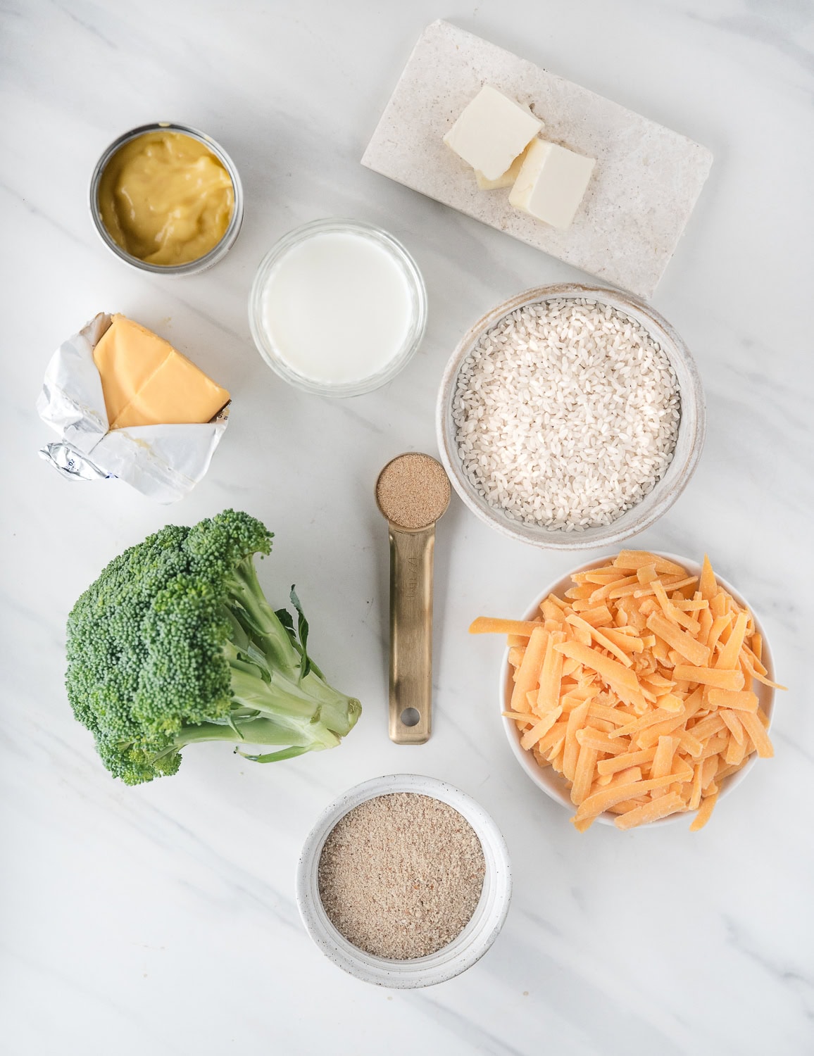 All ingredients shown-breadcrumbs, shredded cheese, broccoli, salt & pepper, rice, Velvetta cheese, milk, butter