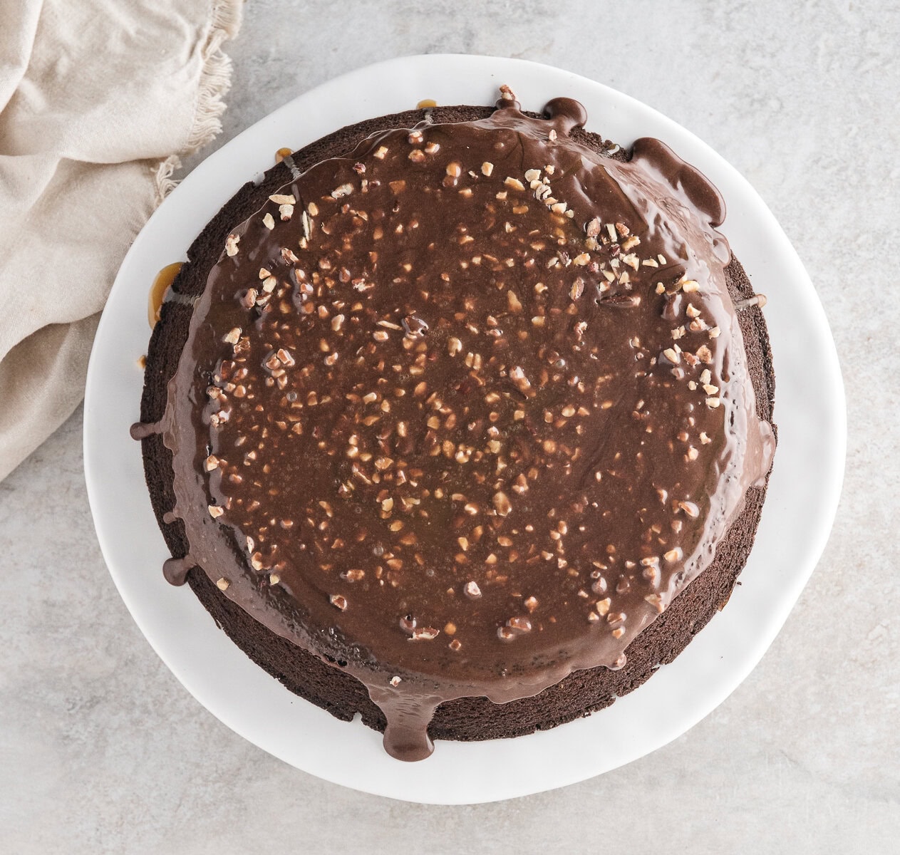 Chocolate Turtle Cake warmed from the skillet with chocolate fudge on top and added nut topping