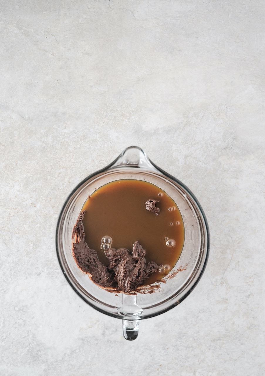 Caramel sauce mixed in with chocolate to create the topping for turtle cake