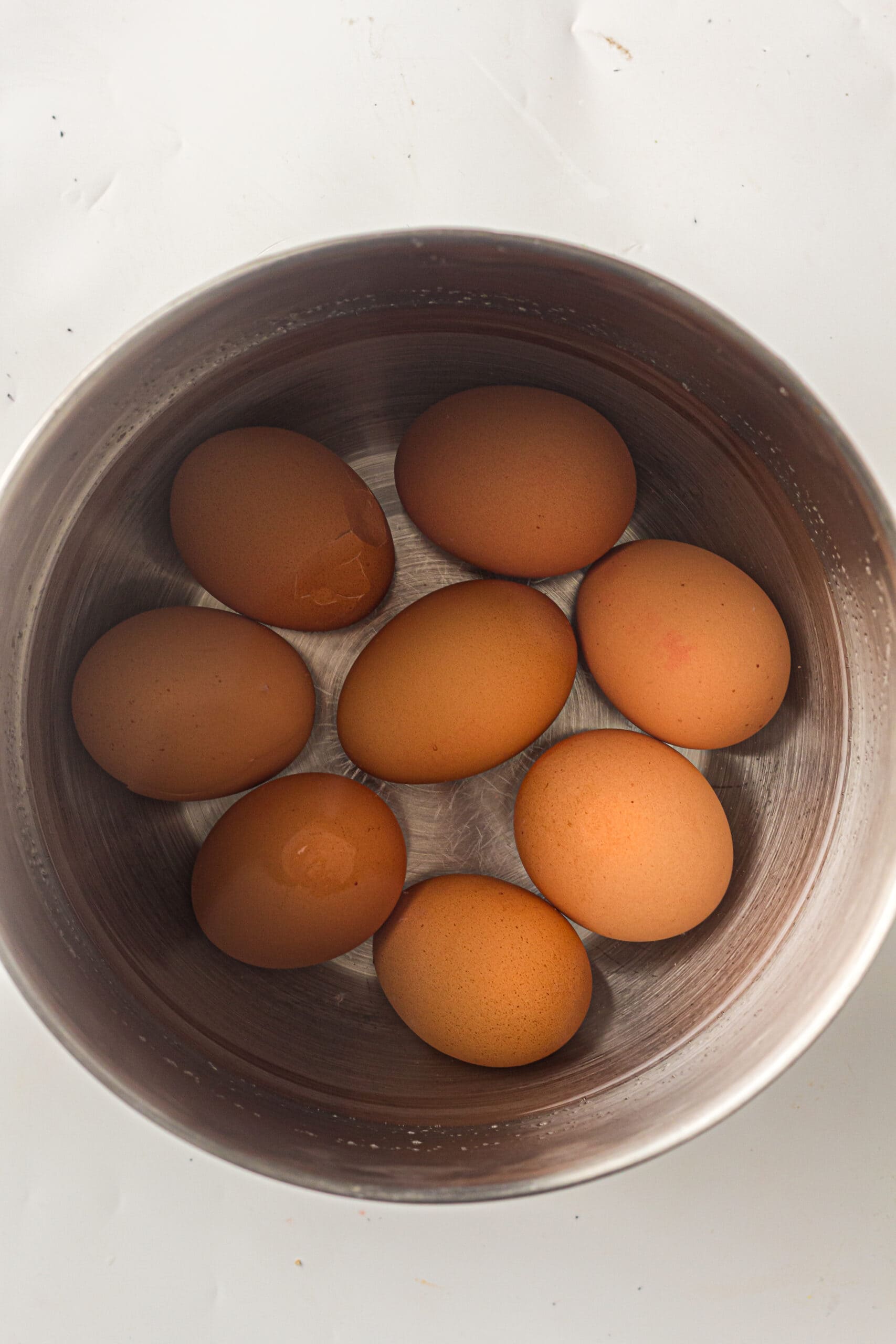 Eggs in water in a pot, ready to be boiled to start the recipe