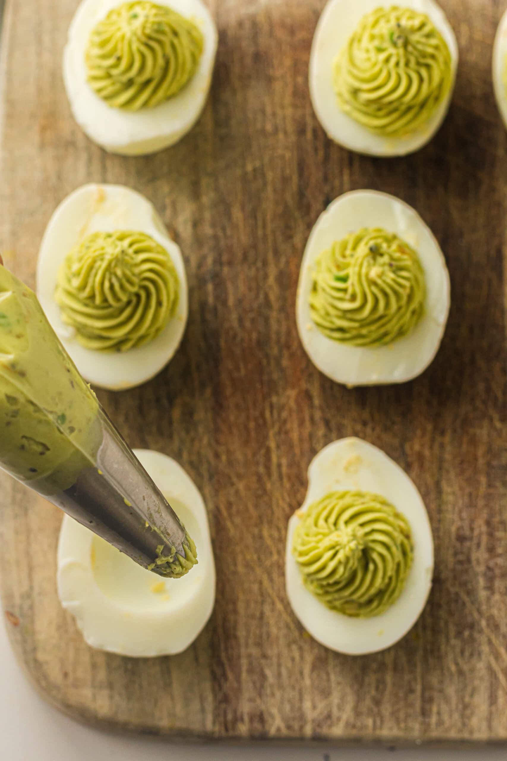 Piping the eggs to create the Christmas tree