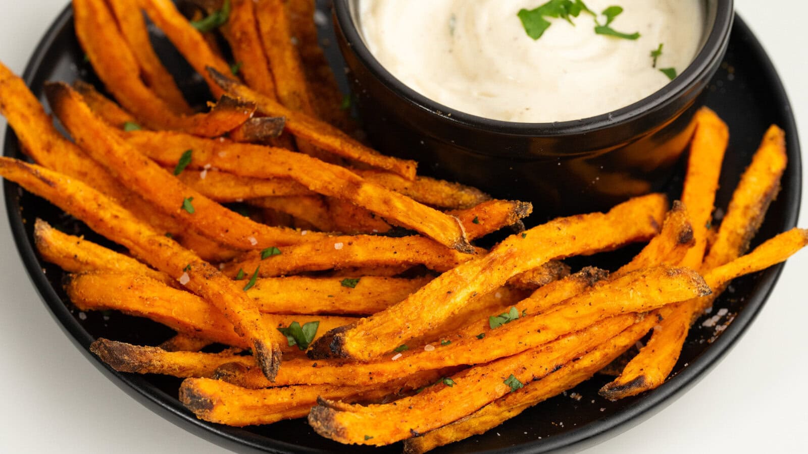 Crispy Air Fryer Sweet Potato Fries all served up, garnished and served with a dip