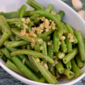 green beans and caramelized onions in a white dish