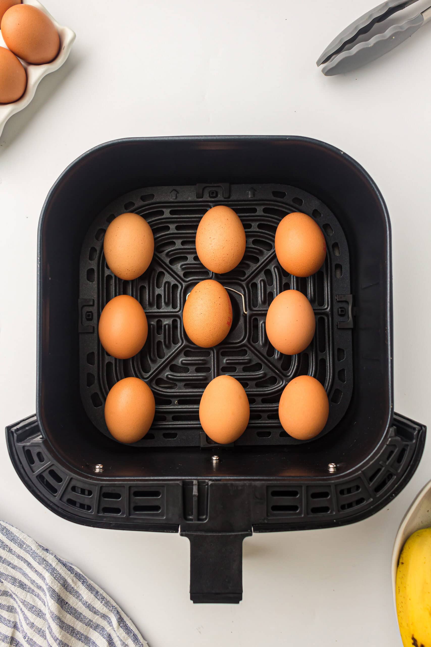 nine raw eggs in the air fryer basket