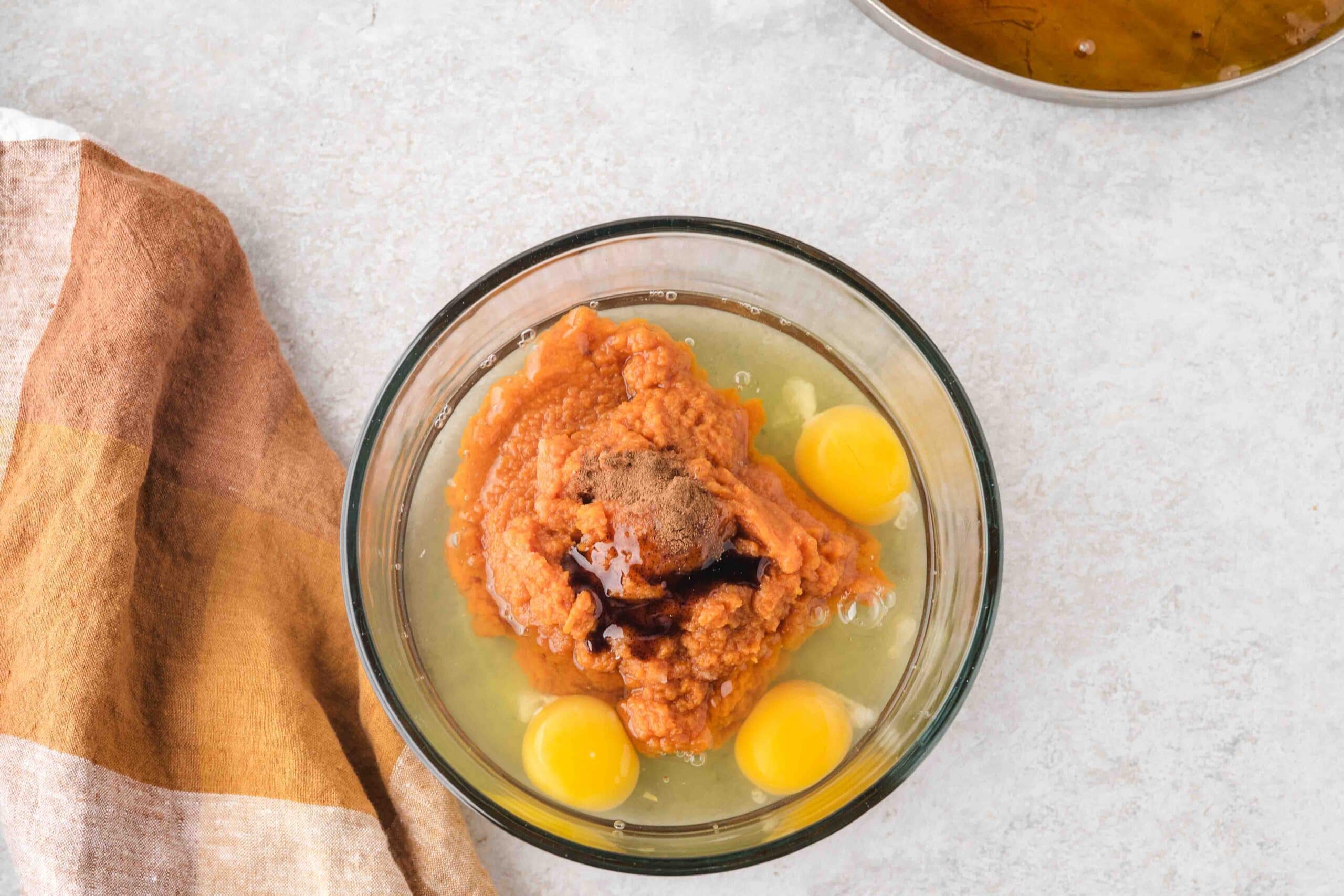 MIxing bowl with canned pumpkin, eggs, vanilla bean extract, egg whites