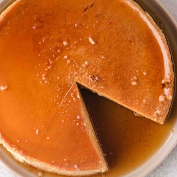 a large pumpkin flan with one slice removed