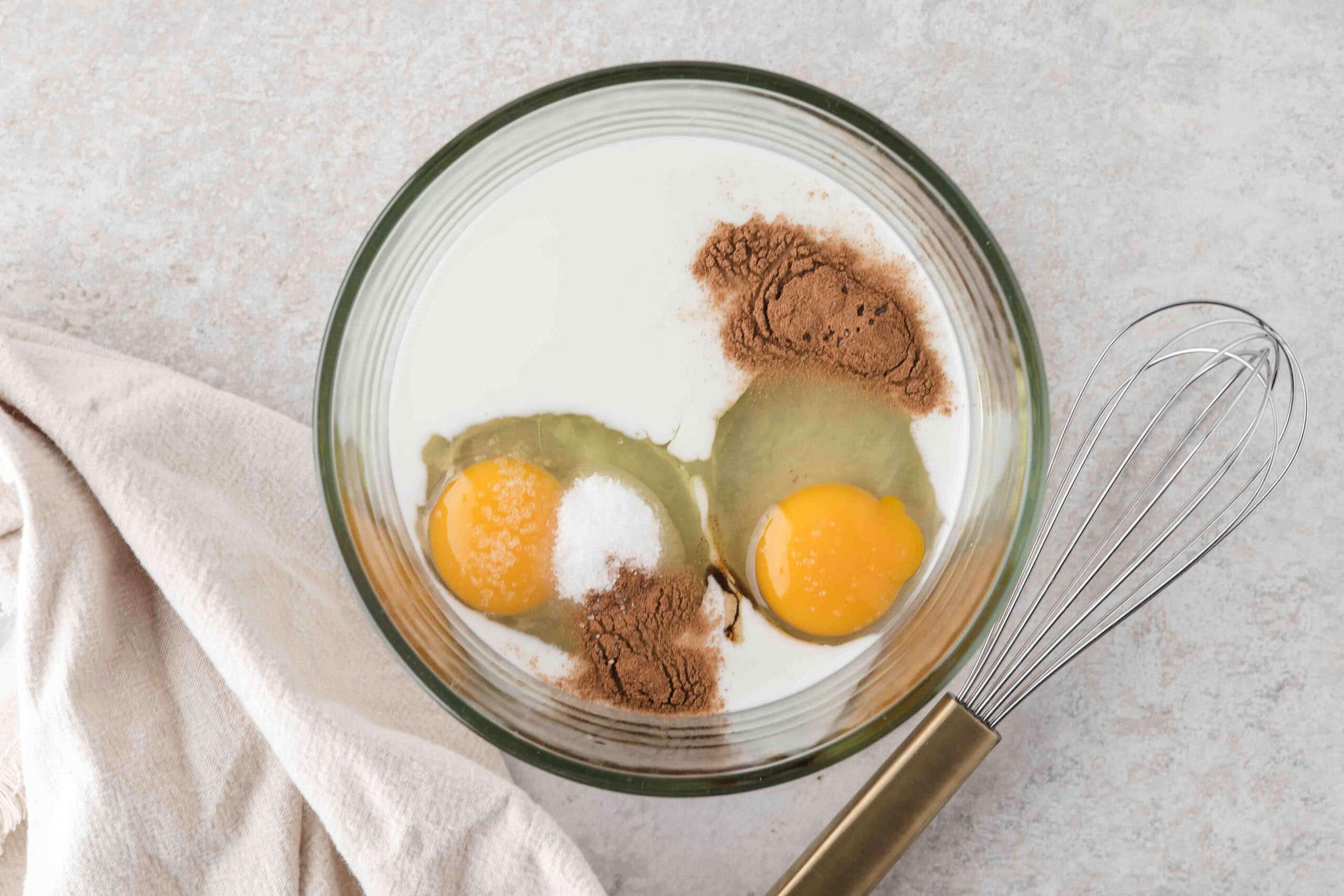 Eggs, cinnamon, milk in a bowl ready to be mixed together to create the batter for the french toast sticks