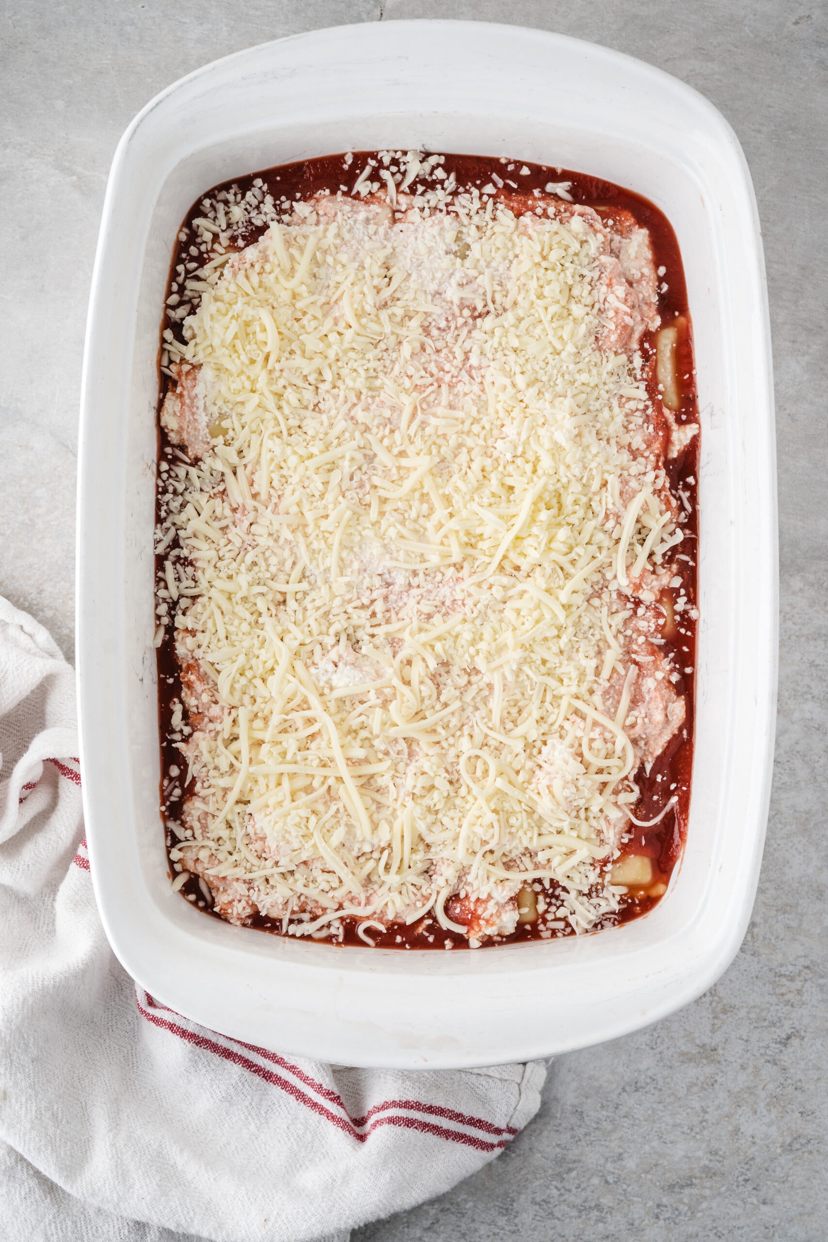 Layering mozzarella cheese in the process step of cheese on top of the ravioli