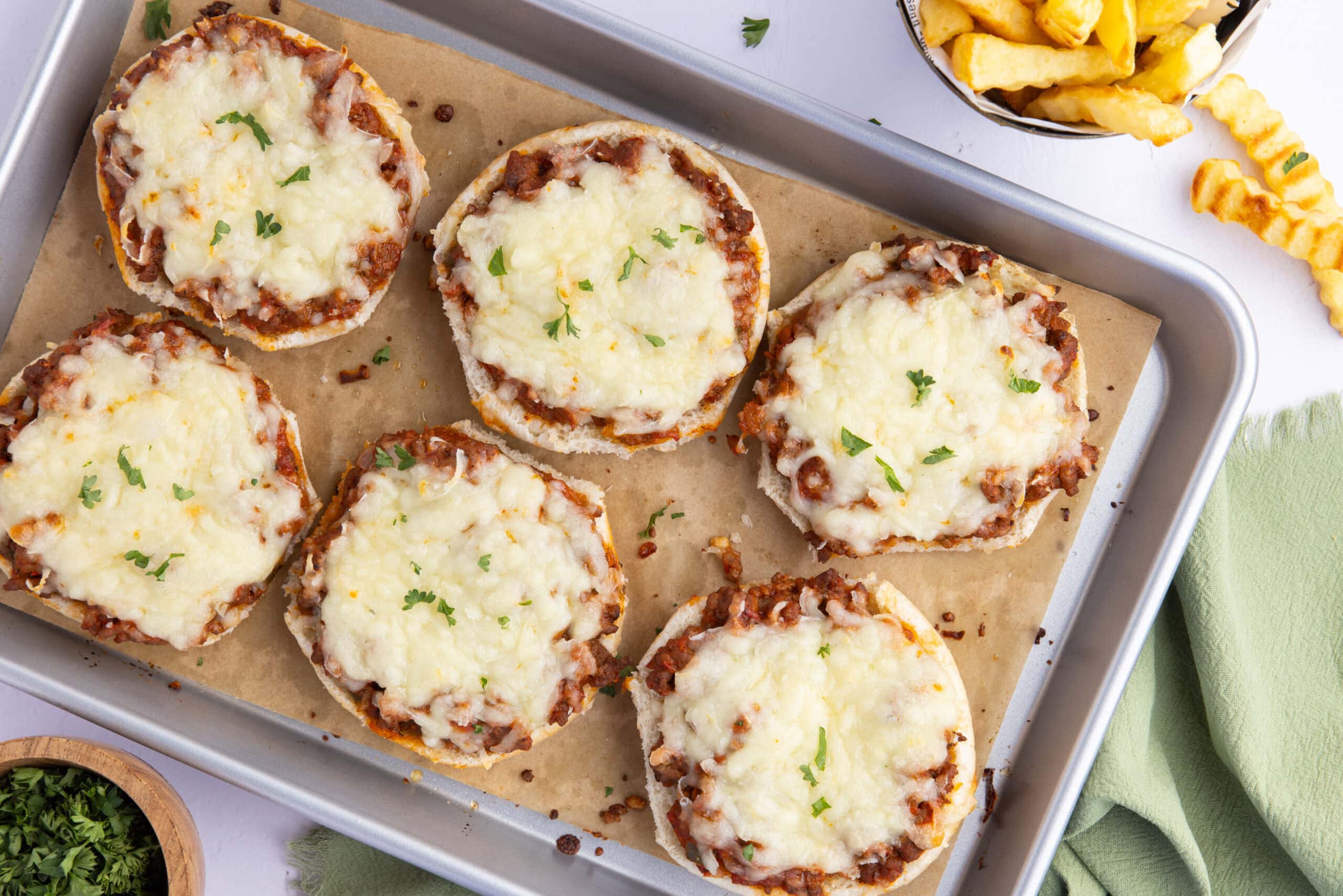 Pizza Burgers all baked and lined on a baking sheet ready to be cooled and enjoyed