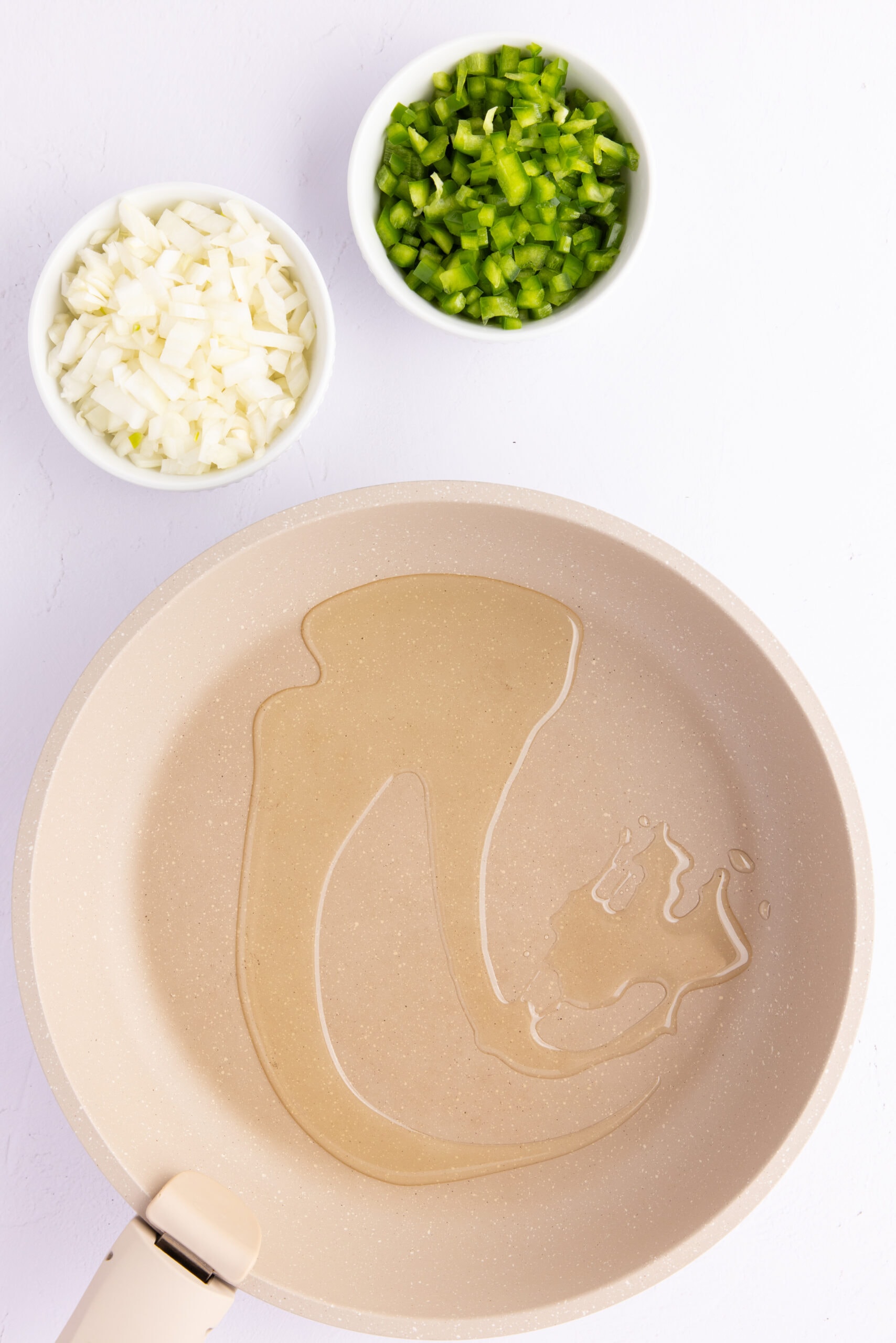 Oil in pan to add diced onions and diced green onions to sauté