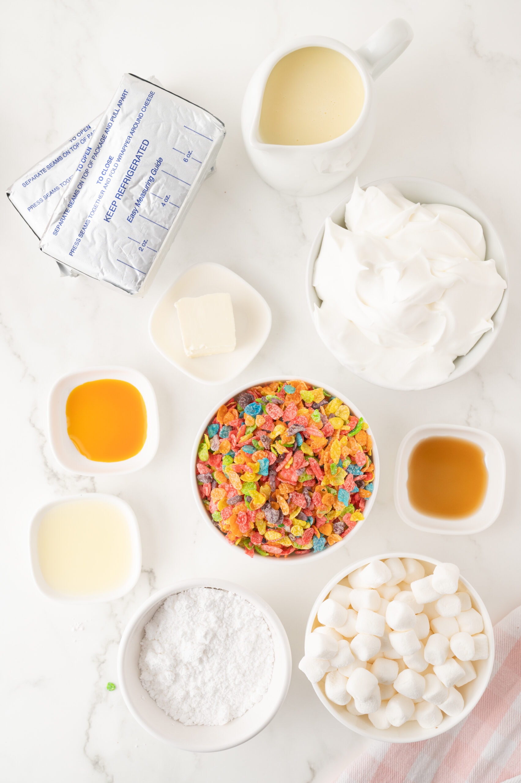 All ingredients pictured : marshmellows, powdered sugar, fruity pebbles, unsalted butter, lemon juice, vanilla & cake batter extract, sweet condensed milk, cool whip, cream cheese,