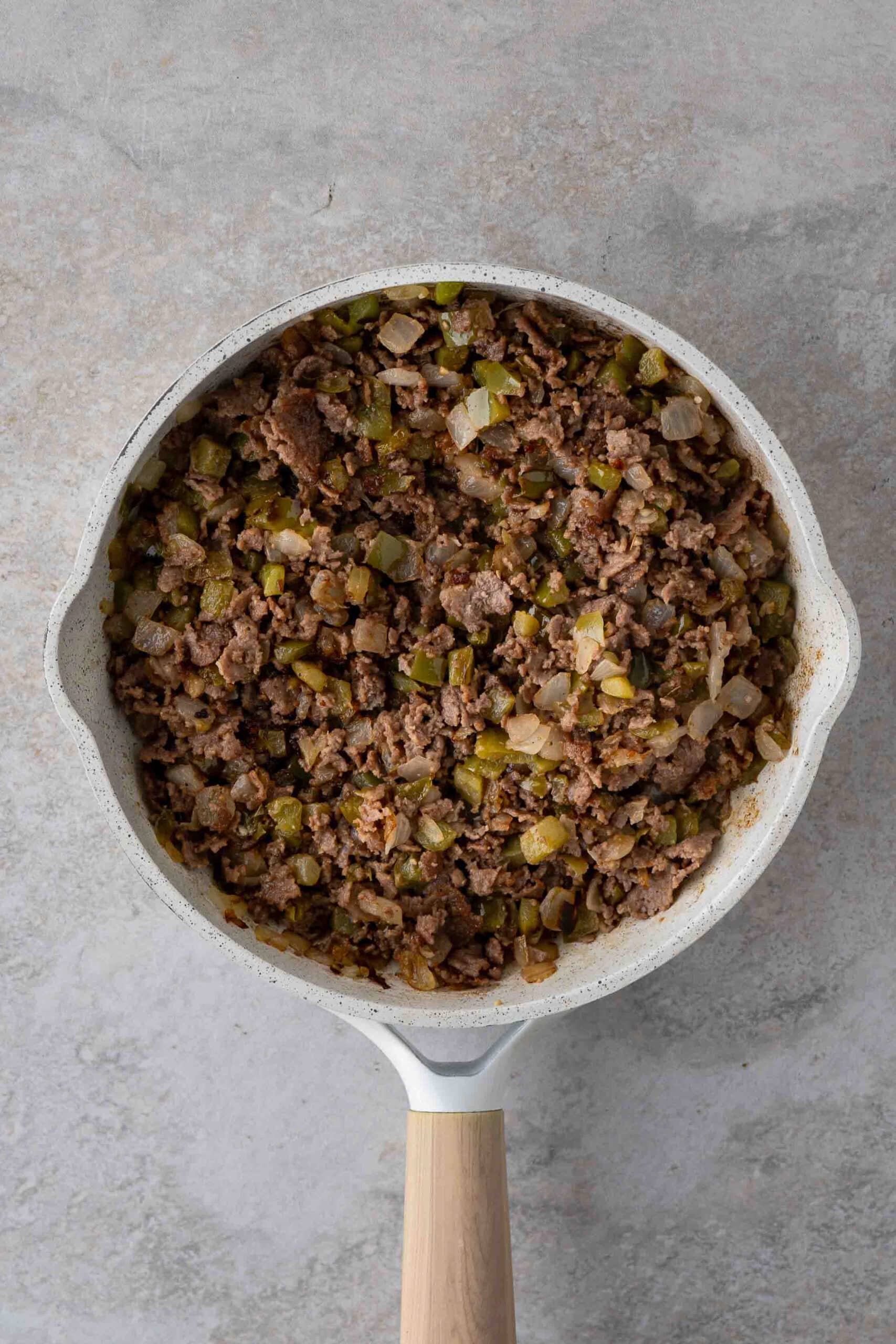 Steak slices all browned up with green peppers and onion together in a saute pan