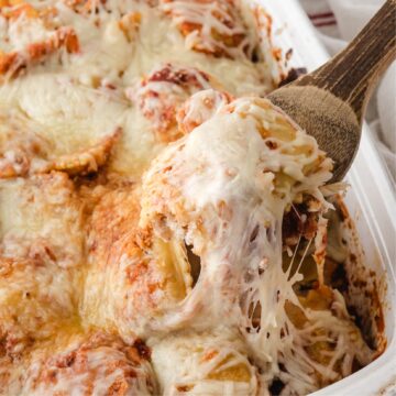 Showing the ooey-gooey cheese on top of baked ravioli