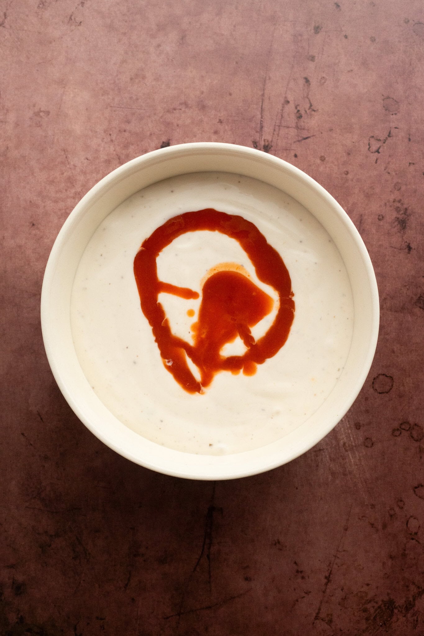 Process of adding ranch dressing with Franks Red Hot Sauce