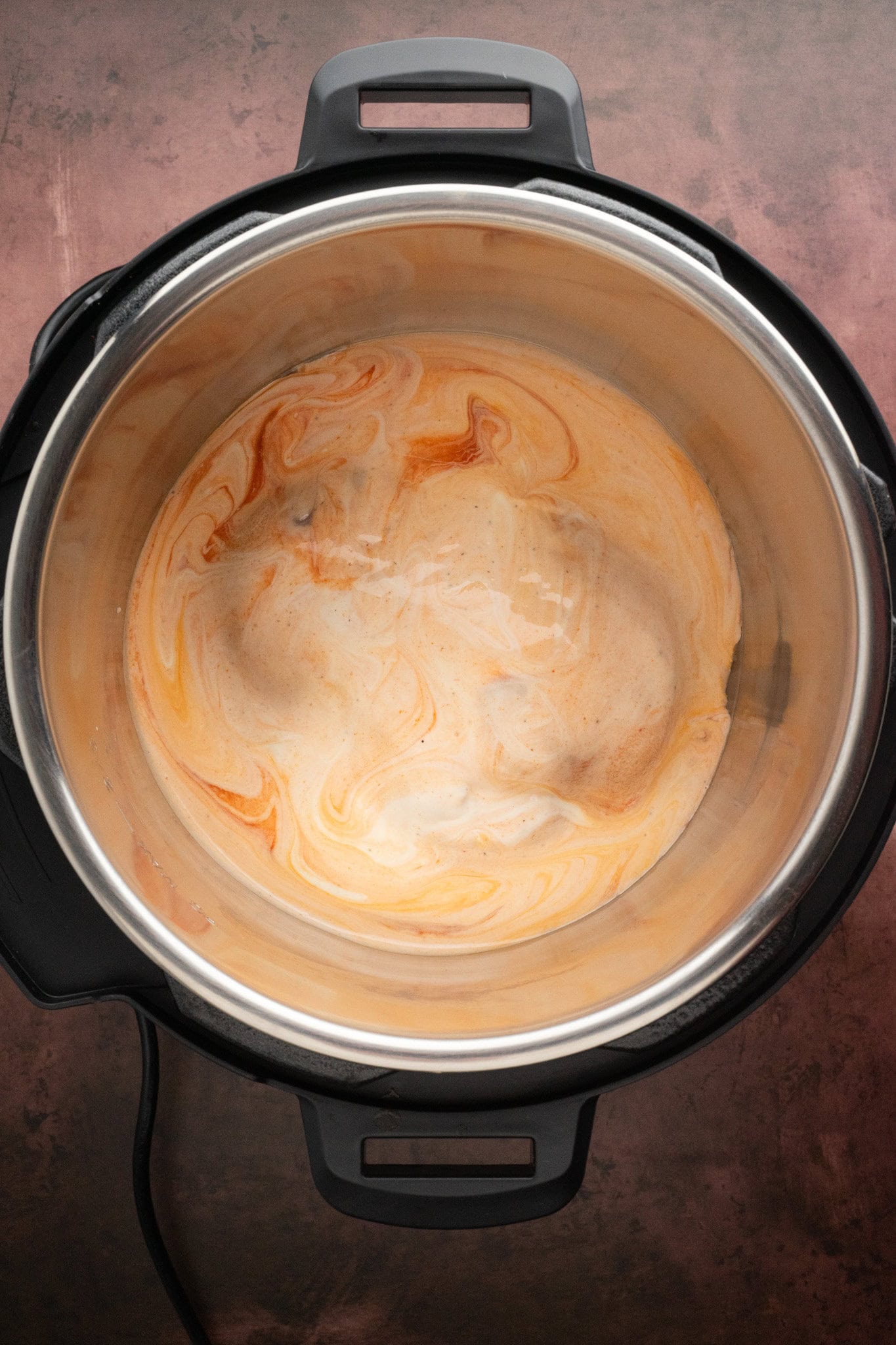 Process of adding cream cheese and shredded cheese to the instant pot