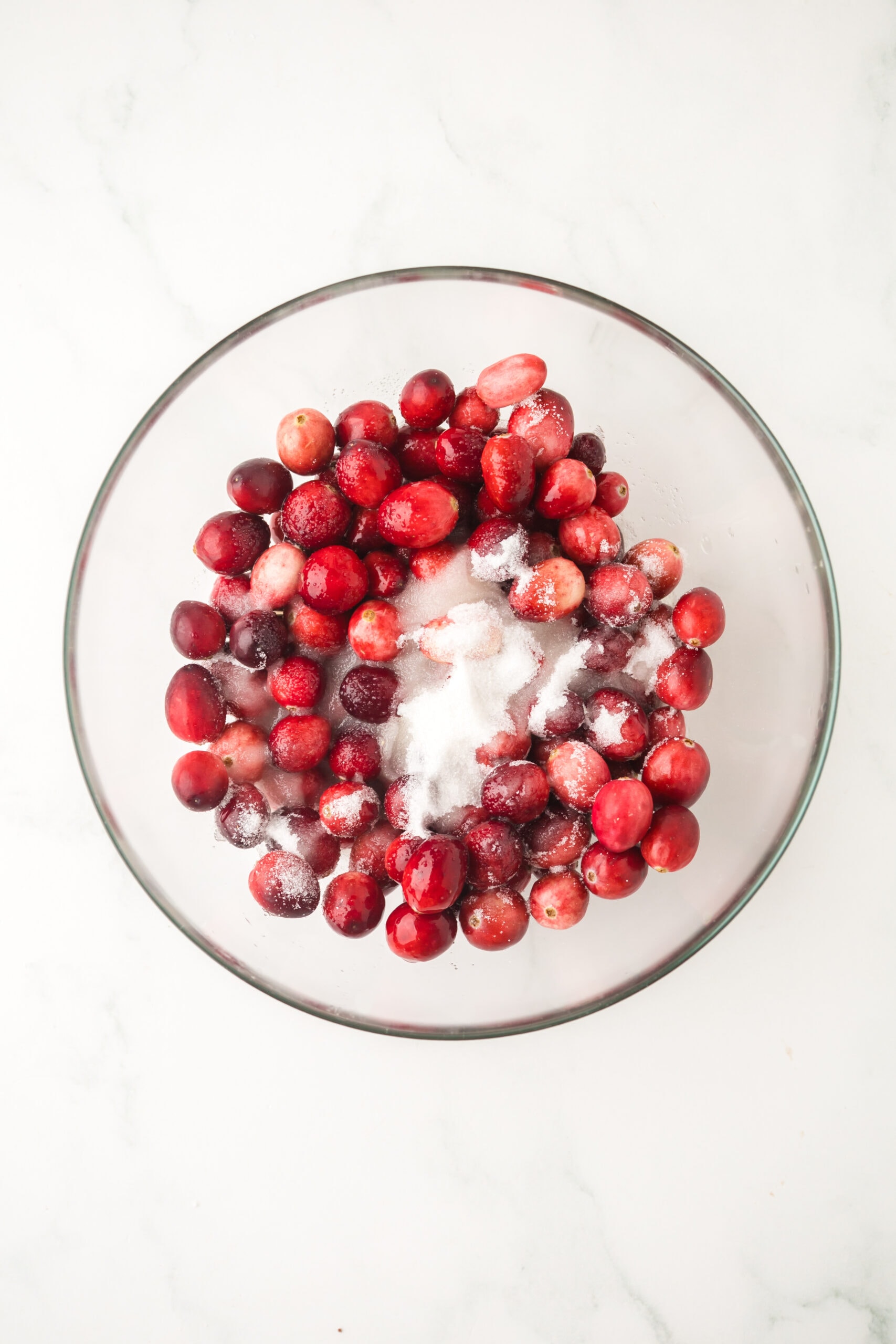 Process photo of fresh cranberries with sugar and lemon juice