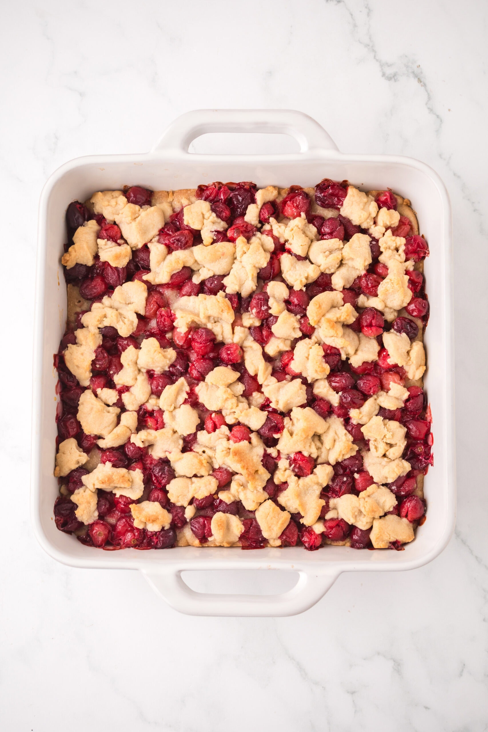 Process of cranberry filing is mixed in with the cookie dough, all baked.