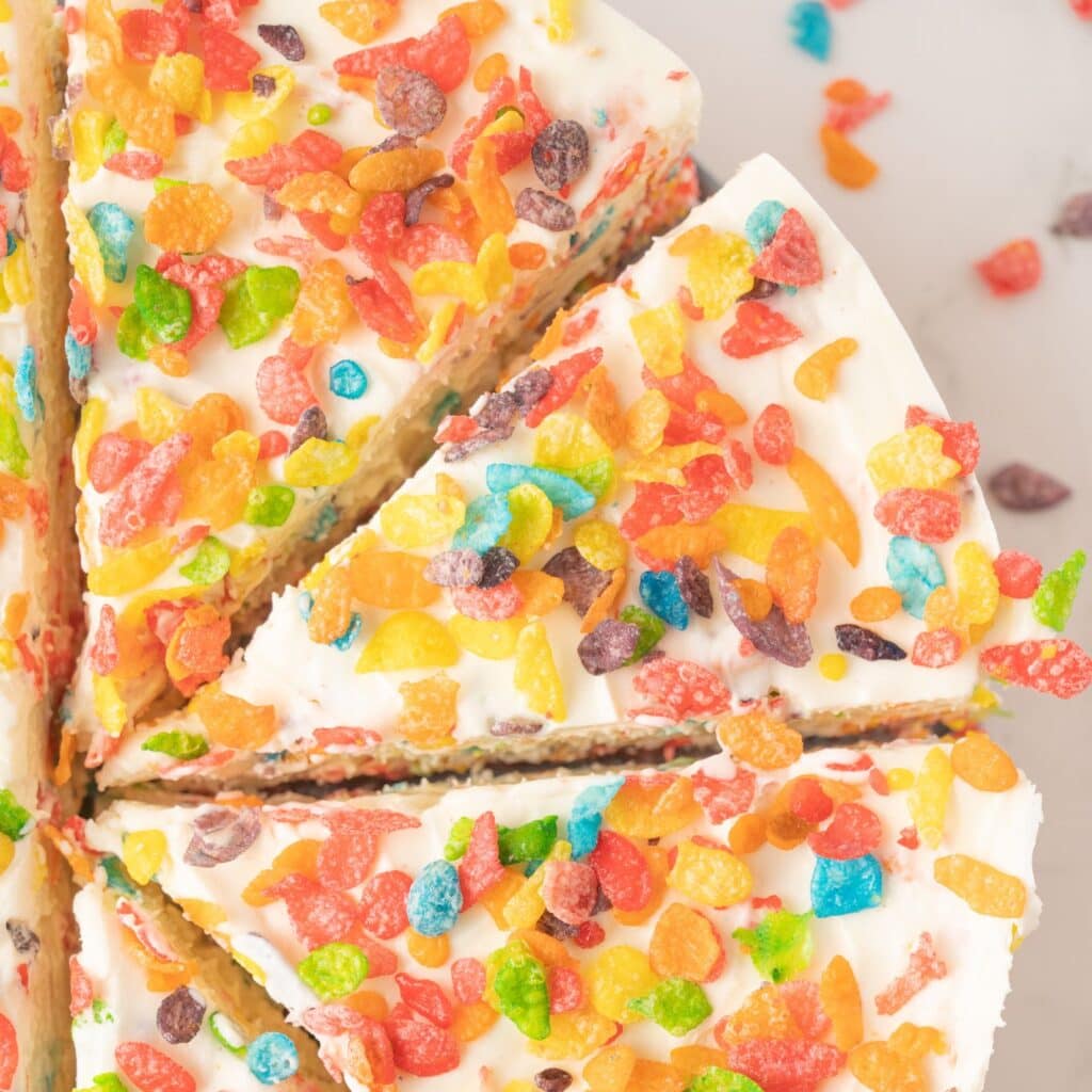 Fruity Pebble Cheeecake cut in slices ready to be enjoyed