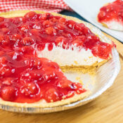 A slice cut out of a no bake cherry cheesecake so you can see the filling.