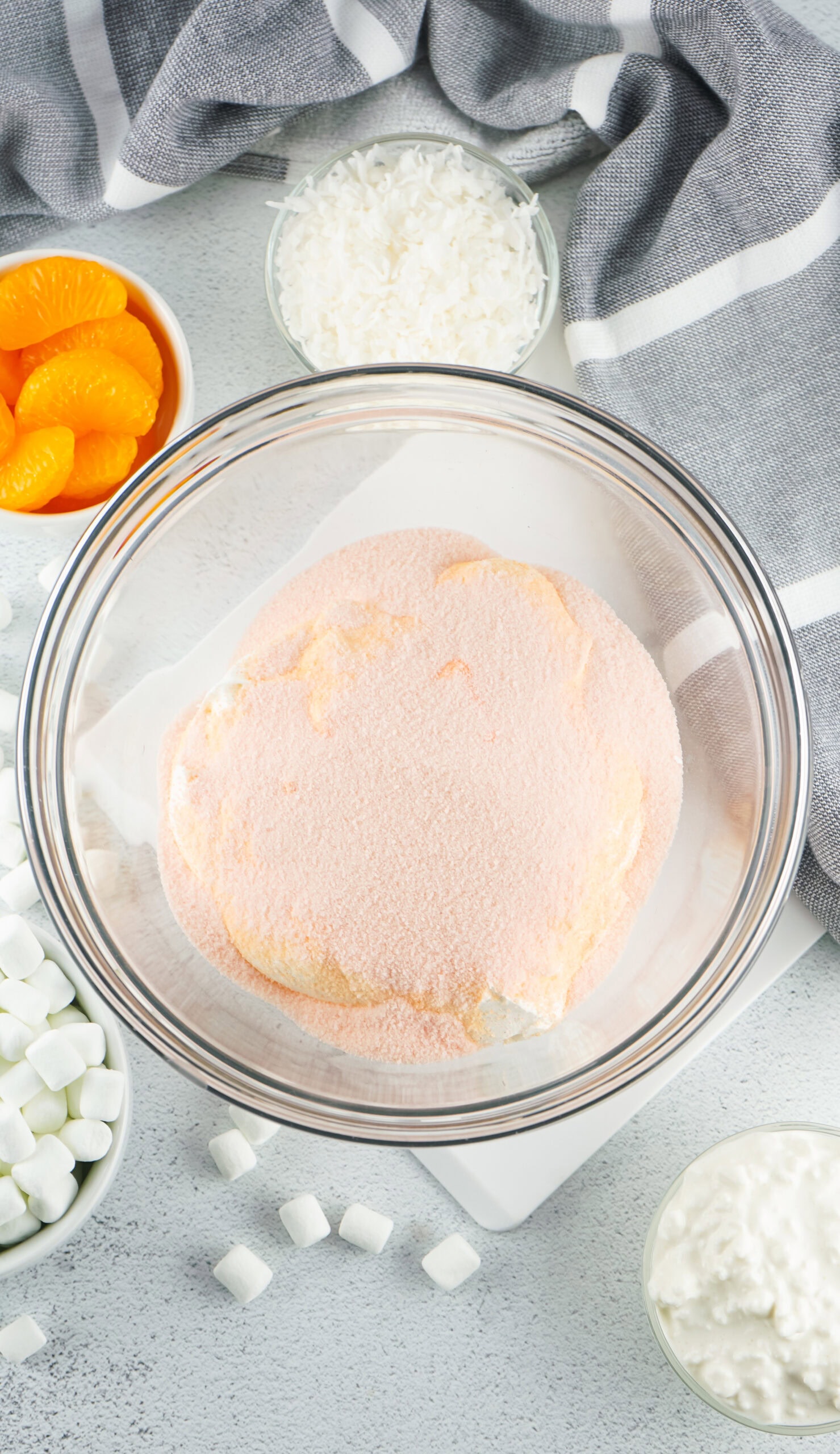 Process of making orange fluff: combining the jello gelatin powder and whip cream