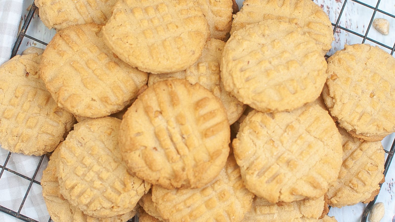 a big stack of air fryer peanut butter cookies on a wire rack