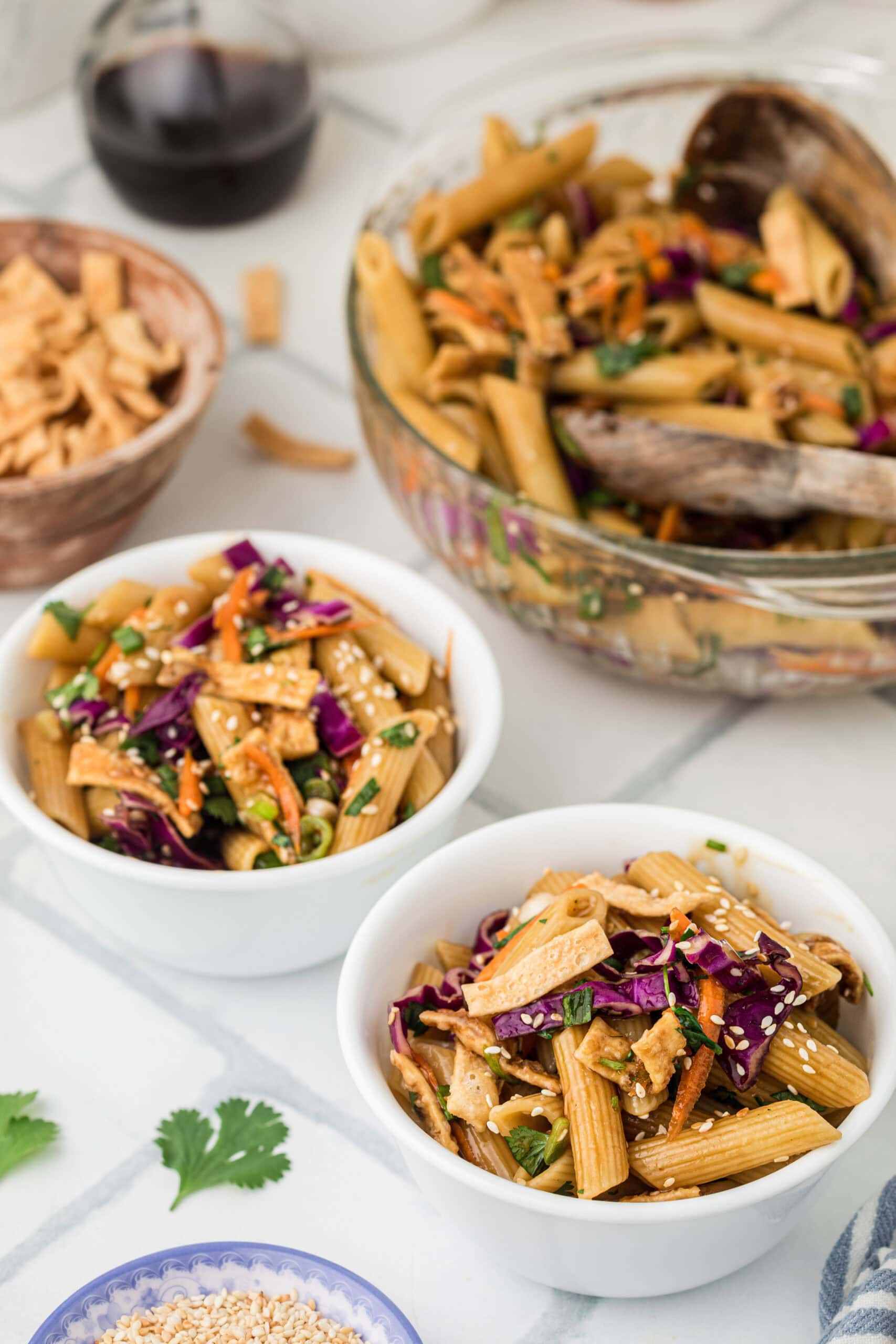Asian pasta salad is plated in two bowls, ready to be enjoyed