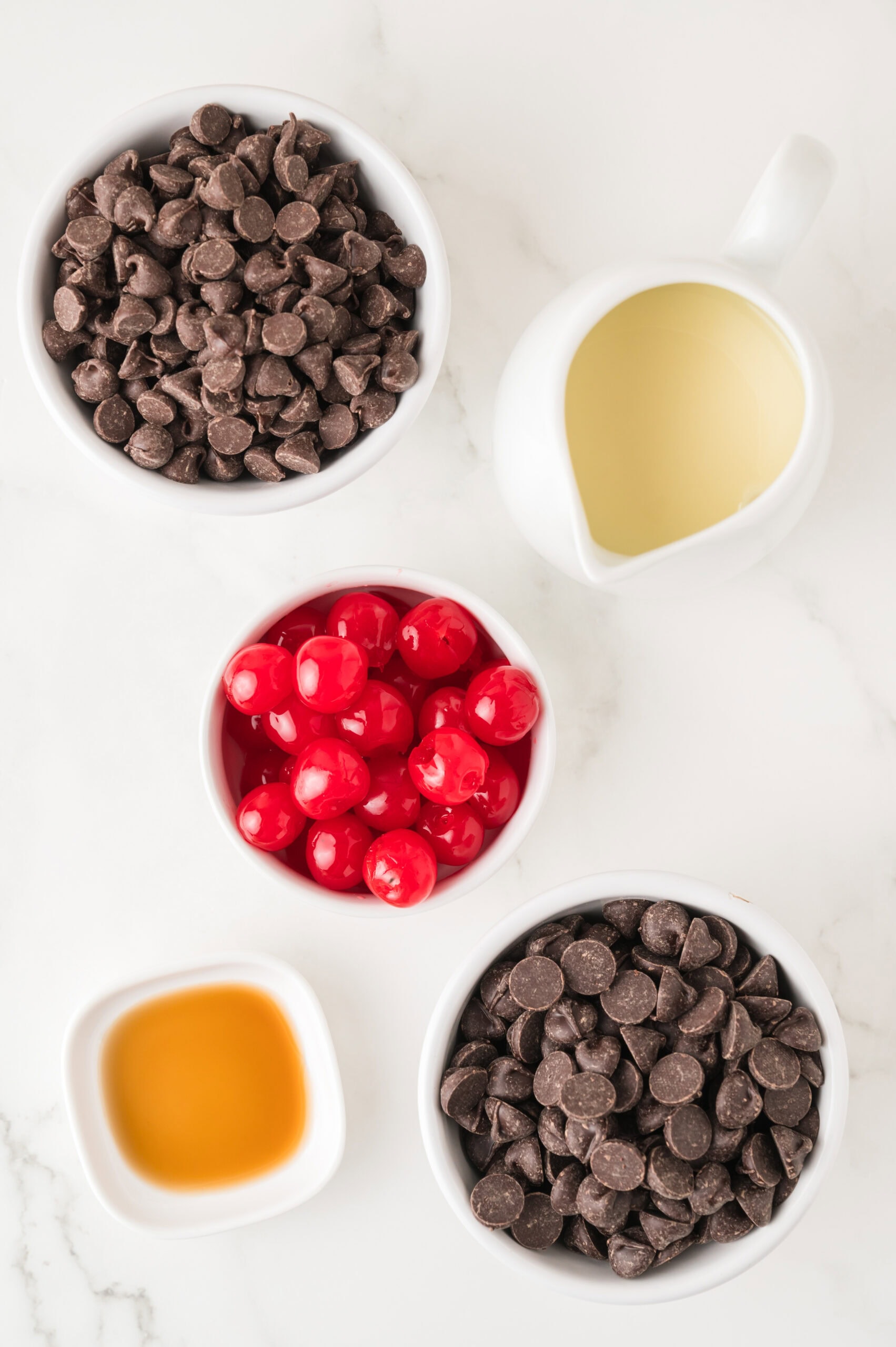 All ingredients pictured : dark chocolate chips, cherries, sweet condensed milk, semi-sweet chocolate chips, vanilla