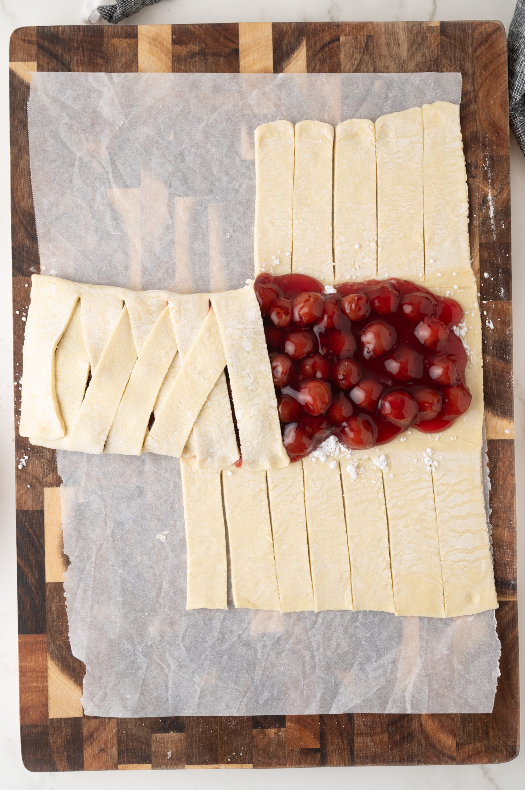 Folding the strips over the cherry pie filling