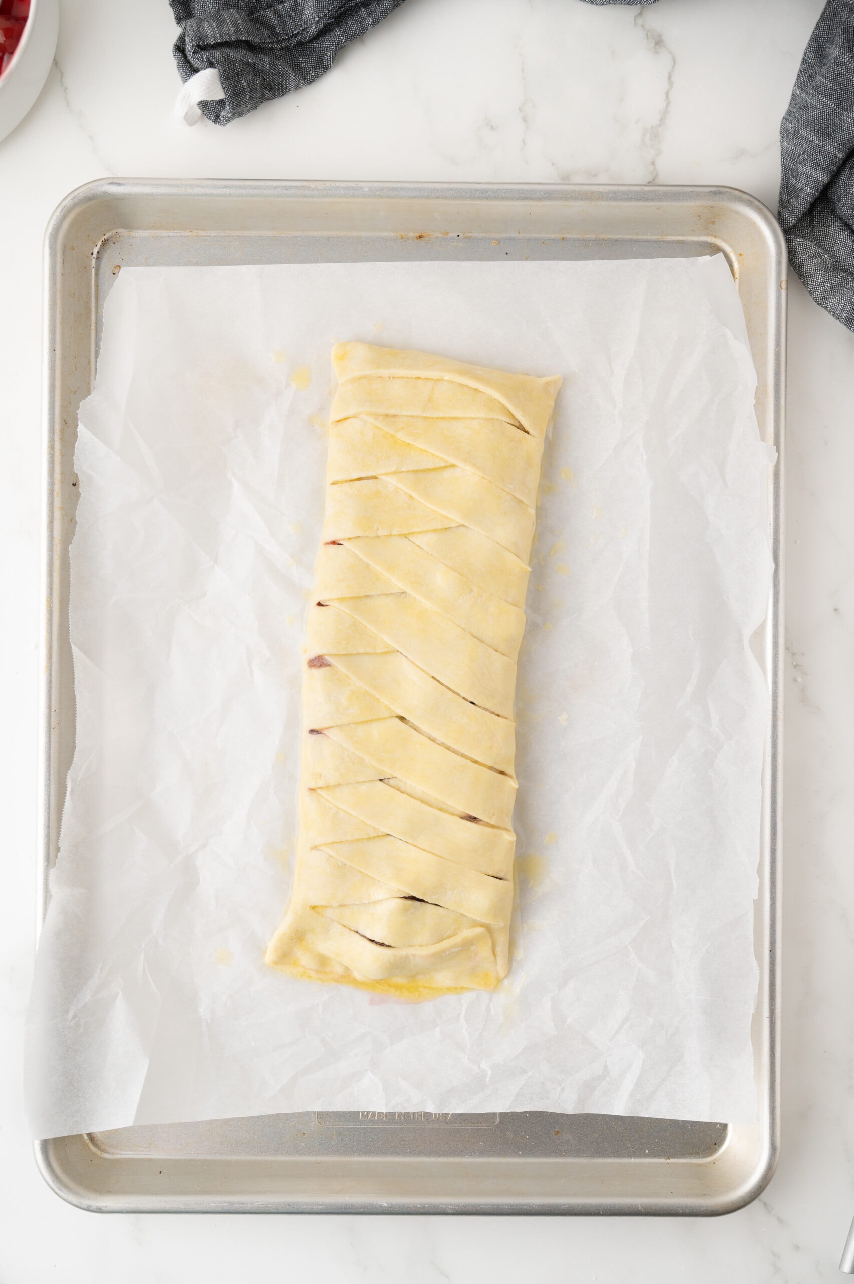 Puff pastry has been created and on a baking sheet, ready to be baked