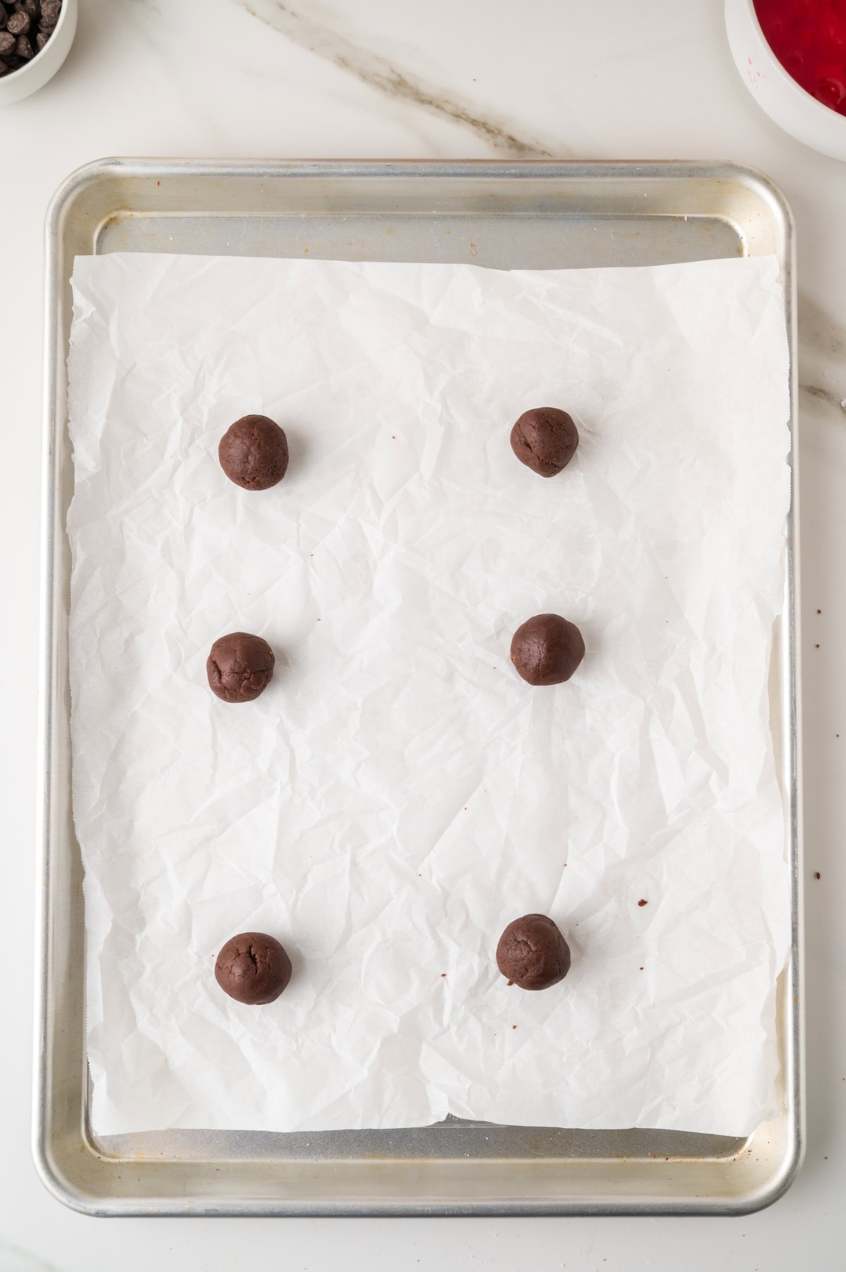 make 1-tablespoon cookie dough balls and place them on a parchment lined baking sheet