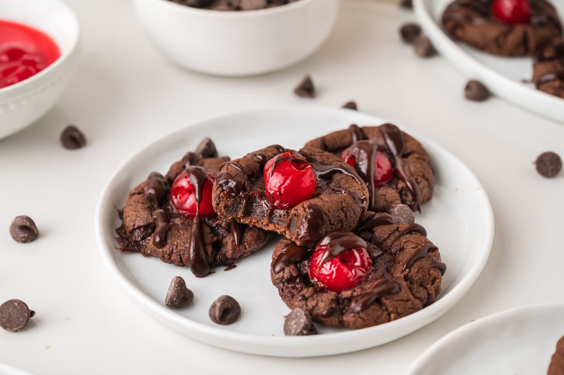 a stack of four cherry chocolate cookies, one with a bite taken out