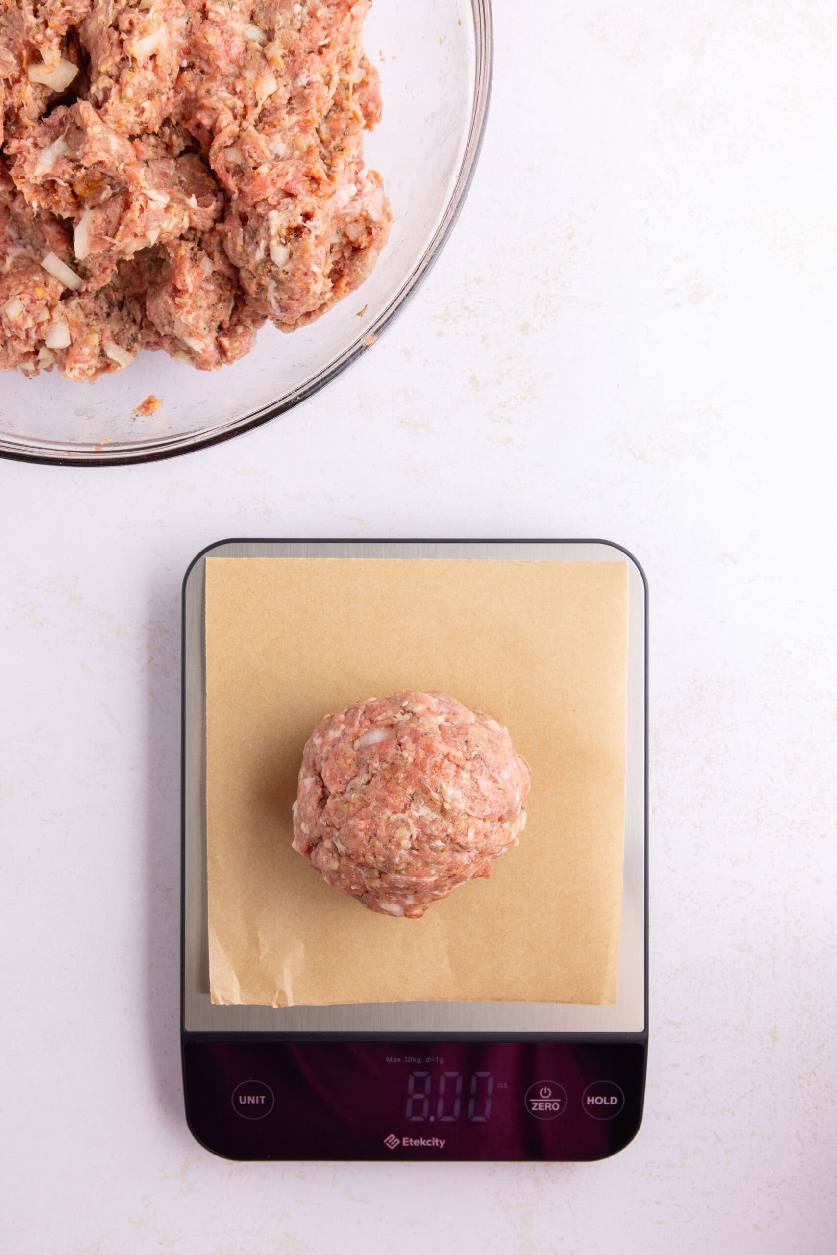 Using a kitchen scale, dividing the meatballs to be equal sized.