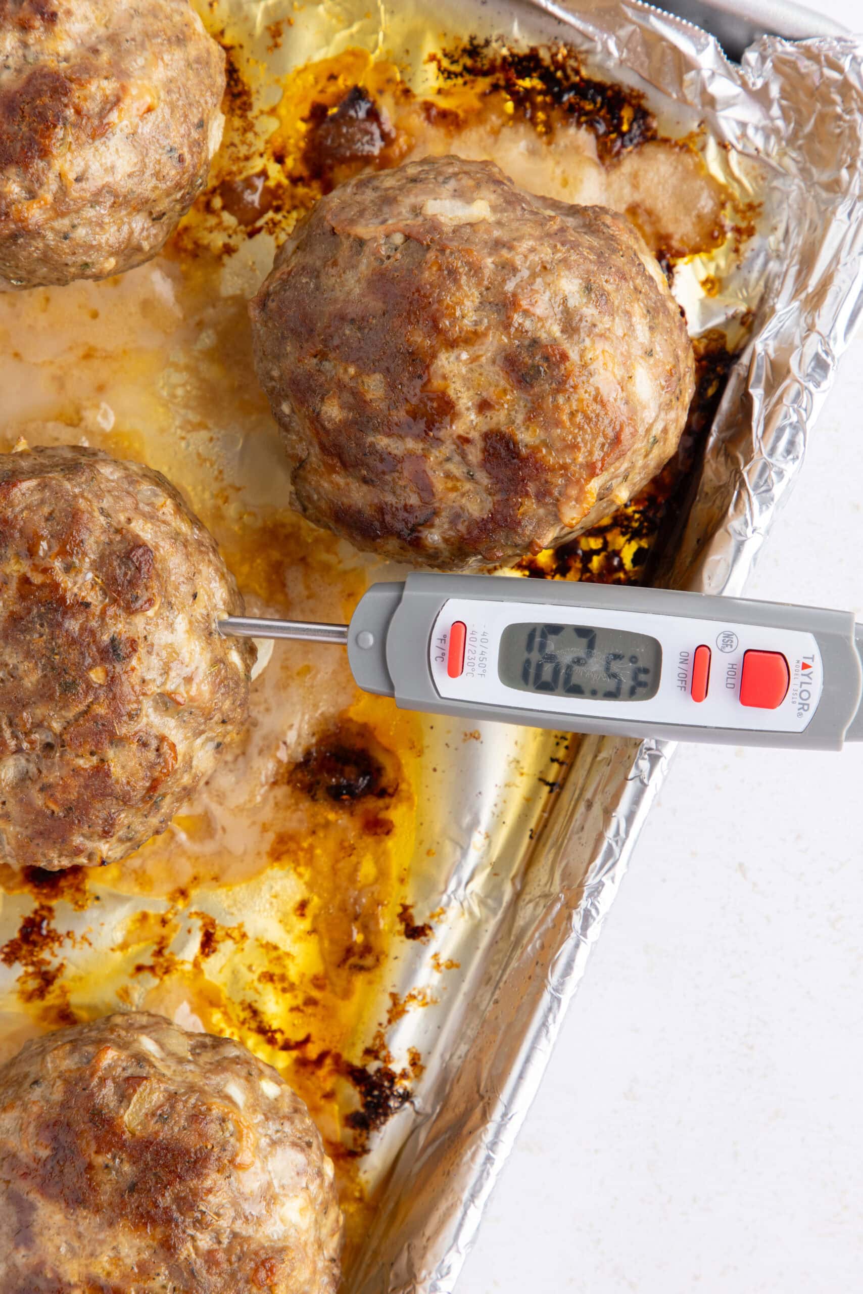 Meatballs are on a baking pan, the internal temp needs to be 165* to be fully cooked, this picture is sharing that.